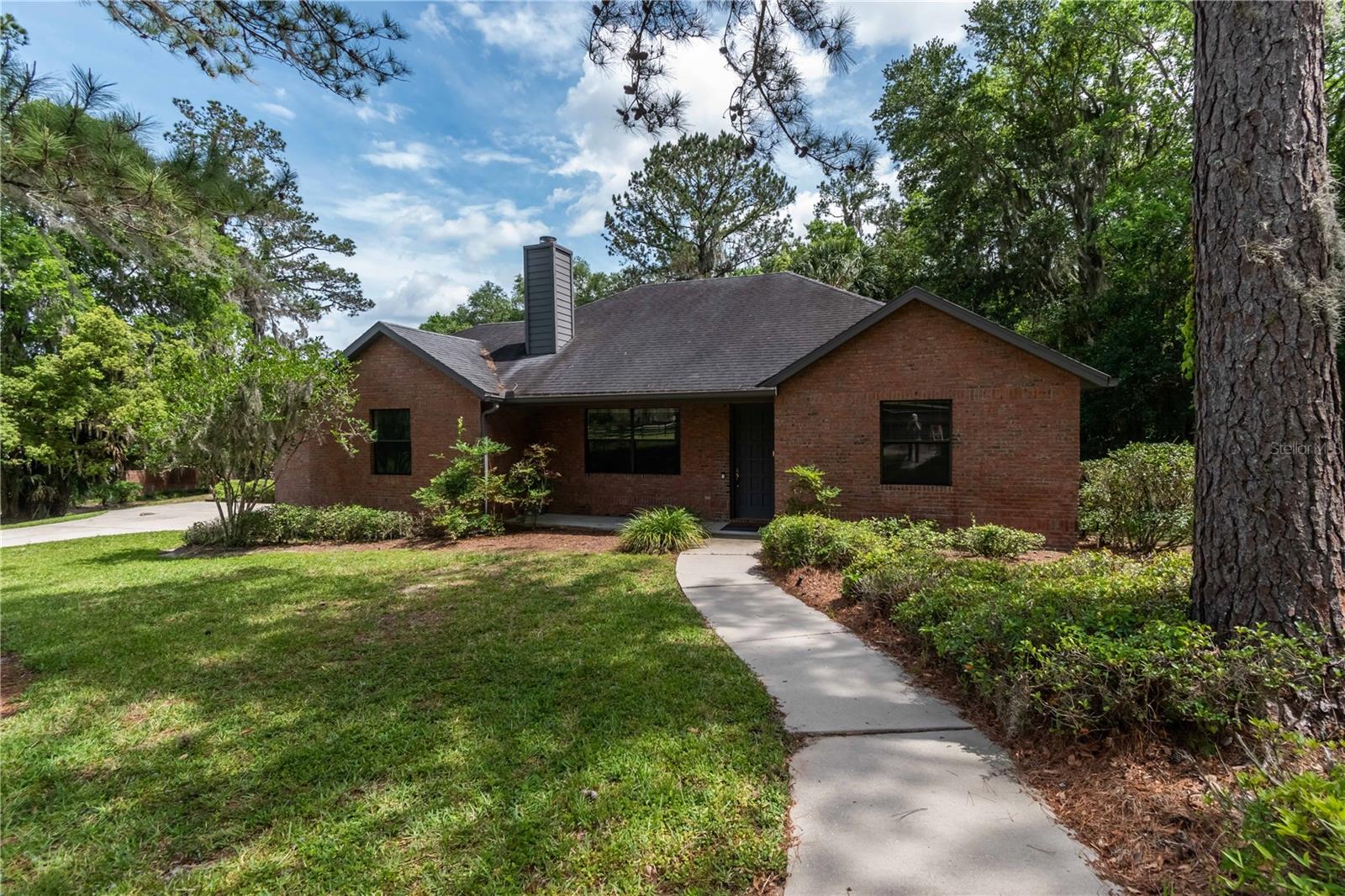Homes at this price point are a rare find in Summit II, making this an exceptional opportunity to enjoy the privacy, space, and convenience this community is known for! Tucked within the peaceful, gated community of Summit II, this inviting residence overlooks 3.7 acres of private, park-like grounds. A separate entrance enhances the sense of privacy, while the setting offers a tranquil backdrop for everyday living. The 2-bedroom, 2.5-bath home is filled with natural light and soaring cathedral ceilings, creating a warm and spacious atmosphere. A flexible office/bonus room provides additional functionality, perfect for work or hobbies. The living room centers around a cozy brick fireplace and flows seamlessly into the kitchen, ideal for entertaining or easy everyday conversation. The kitchen is thoughtfully designed with abundant cabinet and counter space, a center island, and matching appliances. Both bedrooms are generously sized, but the primary suite is a true retreat with its walk-in closet and private en-suite bath featuring a glass-enclosed shower and extended counter space. Additional highlights include a large 2-car garage, indoor laundry room, and plenty of room to enjoy the property’s expansive acreage. The quiet community setting is balanced by its convenient location, with shopping, dining, medical facilities, and entertainment just minutes away. This Summit II home offers the perfect blend of comfort, privacy, and accessibility—all within one of Central Florida’s most desirable gated communities.