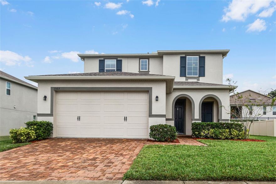 One or more photo(s) has been virtually staged. This stunning 4-bedroom, 3.5-bath two-story residence with a loft and 2-car garage is a masterpiece of modern living. Located in the gated Arden Park neighborhood and nestled on an oversized premium lot, this home offers a perfect blend of privacy and scenic views of the lake from your front porch. Upon entering, you're greeted by the elegance of porcelain wood-look tile floors that seamlessly flow throughout the first floor. The expansive great room effortlessly connects to the open kitchen, boasting beautiful white cabinetry, a counter-height island wired for pendant lighting, a subway-tiled backsplash, a stainless steel hood, and top-of-the-line appliances, including a built-in oven, microwave, and a 5-burner gas stove top. The kitchen also features a large walk-in pantry, catering to all your storage needs. The spacious dinette area, adorned with sliding glass doors, leads to a screened lanai and a backyard, perfect for entertaining or enjoying peaceful evenings. A well-appointed bedroom with an en-suite bath on the first floor offers convenience and versatility. Ascend the beautiful wood stairs to the second floor, where wood laminate flooring guides you through the loft, creating a perfect space for relaxation or recreation. The primary suite is a haven of luxury, featuring a trey ceiling, an expansive en-suite bath with a double sink vanity adorned with granite, a soaking tub, and a walk-in shower. A walk-in closet completes the primary suite. Two additional bedrooms on the second floor share a full bath with a double sink vanity graced by granite countertops. A large laundry room on the second floor adds practicality to daily living while the added comfort of a water softener, provides benefits like smoother skin and preserving appliance longevity.  As a resident of Arden Park, you'll enjoy a plethora of community amenities, from the resort-style pool and well-equipped fitness center to the clubhouse available for rental. The community also offers several playgrounds and picnic areas, serene lakeside paths, and scenic walking trails, ensuring a lifestyle of comfort and recreation. Conveniently located near the 429, this home provides easy access to transportation routes, as well as a variety of shopping and dining options. Also, the West Orange Trail is located right outside the entrance to the neighborhood providing 22 miles of paved trails for your biking or skating enjoyment. Don't miss the opportunity to make this exquisite property your own—schedule your showing today!