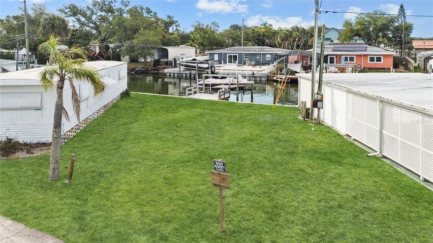 SELLER WILL DO SELLER FINANCING WITH A 30% DOWN PAYMENT. Imagine ending your day with the sound of water just steps from your door and your boat waiting in the backyard—this is the lifestyle this waterfront lot delivers.
Located in a welcoming, resident-owned 55+ community in St. Petersburg, this cleared parcel is ready for your elevated dream home. Positioned along a canal with direct access to Boca Ciega Bay and Madeira Beach, it comes complete with a private dock and 10,000 lb boat lift—making it easy to head out for a day on the water whenever you choose.
The setting offers a peaceful coastal atmosphere where you can enjoy fishing from your own dock or watching manatees pass by. With nearly 60 feet of waterfront, there’s plenty of space to create your ideal outdoor retreat.
The community enhances the experience with its own private boat ramp, nearby marina, and a mix of full-time residents and seasonal homeowners who appreciate relaxed Florida living. Conveniently located just minutes from shopping, dining, and the Bay Pines VA Hospital, everything you need is close at hand.
Whether you’re planning a seasonal escape or a full-time residence, this is your chance to build something special in a location that truly captures the best of waterfront living!