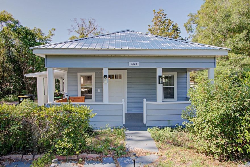 Charming Fully Restored Cottage-Style Home on a Spacious Corner Lot in Orange City. This beautifully updated cottage-style home is the perfect starter home, retirement retreat, or turnkey investment opportunity. Nestled on a quiet, lovely street and situated on almost 1/2 acre corner lot, this property offers comfort, charm, and modern upgrades all with no HOA. Features include: Brand-new metal roof, Refinished original solid wood floors throughout, Modern kitchen with quality cabinetry and Corian countertops, Gas range, full-size refrigerator, dishwasher, and microwave included, Stainless steel double sink with garbage disposal, Upgraded aluminum windows, Gas water heater, Fresh interior and exterior paint, Ceiling fans in every room, Updated lighting fixtures throughout, Inside laundry room with washer/dryer hookups, half bath, utility sink, Spacious primary and secondary bedrooms with closets, Attached covered carport, Expansive almost 1/2-acre shaded lot with mature trees.