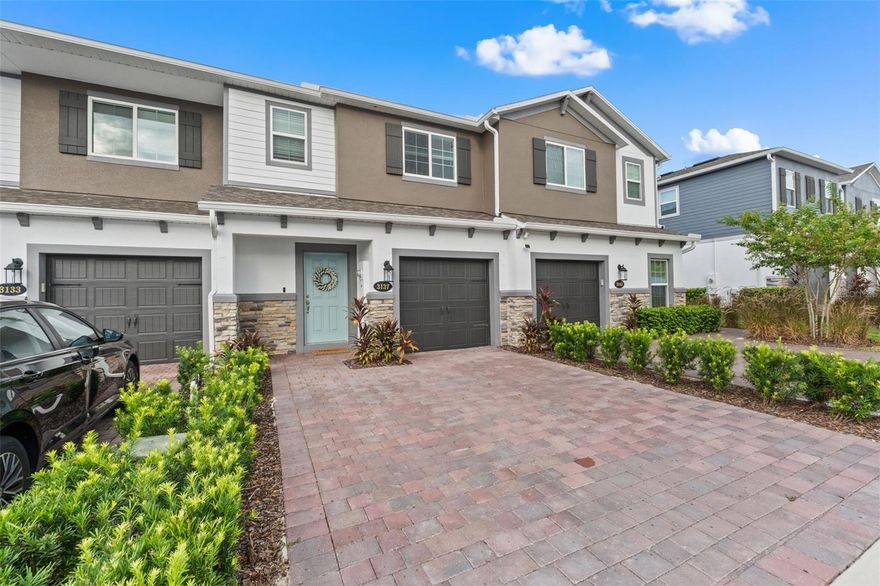 Welcome to this stunning 3-bedroom, 2.5-bathroom townhome built in 2023, offering 1,569 sqft of modern design and comfort in a prime location. Step inside to find beautiful wood-look tile throughout the first floor and cozy carpet in the upstairs bedrooms and loft. The open-concept kitchen and living area is perfect for entertaining, featuring sleek quartz countertops and stainless-steel appliances. Enjoy your own private back patio with no rear neighbors. The one-car garage includes upgraded epoxy flooring, and the paver driveway adds a touch of elegance. Located in a gated community with a dog park, this home offers both security and amenities. You're just 5 minutes from SR-417, 10 minutes to UCF, and 20 minutes to Orlando Executive Airport—making this an unbeatable location for commuters or professionals. Don’t miss your chance to own this beautiful, move-in-ready home!