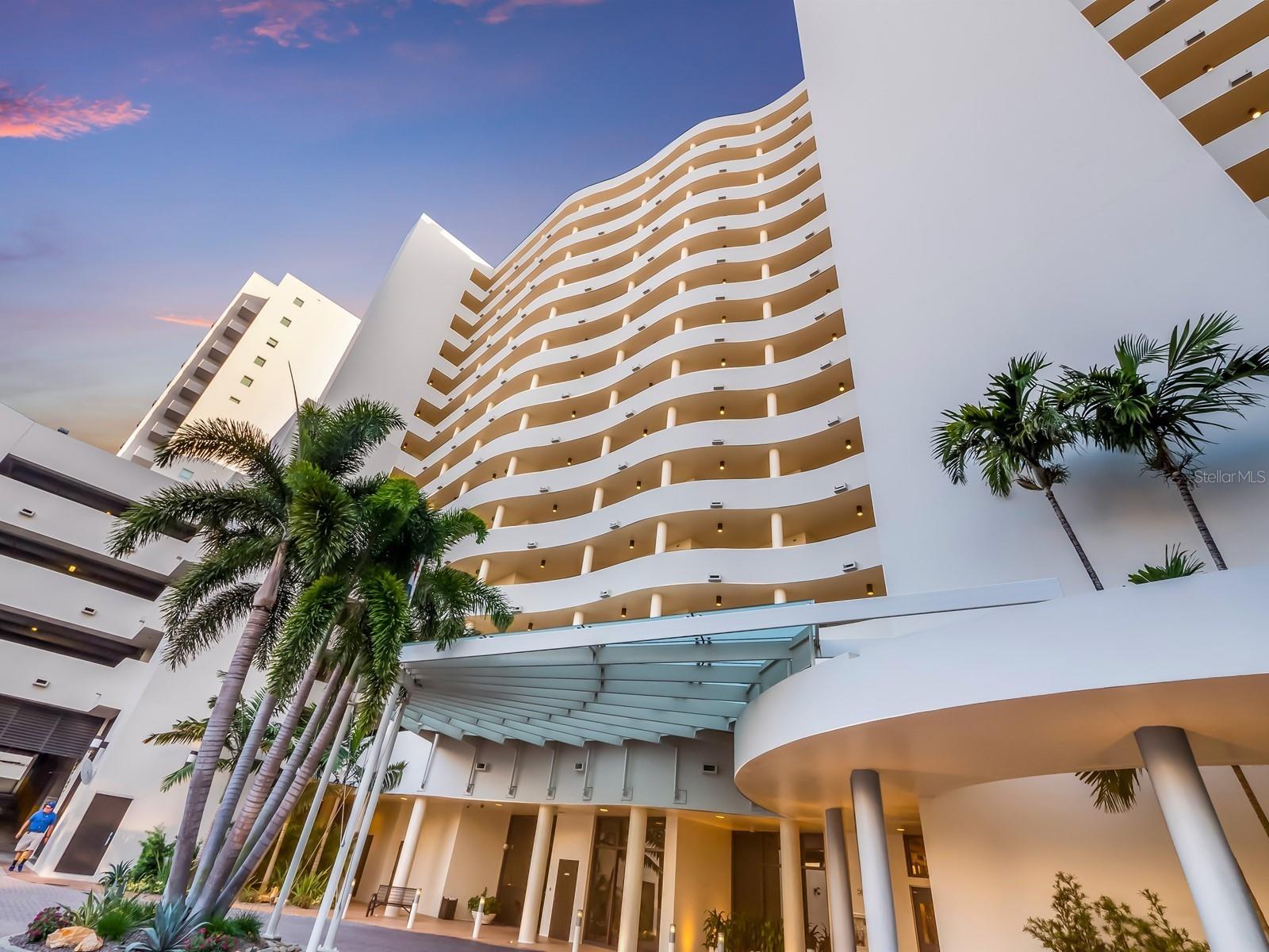 One or more photo(s) has been virtually staged. Welcome to a stunning condominium that offers captivating water views! Imagine waking up to panoramic scenes of Sarasota Bay, Marina Jack's, and the gorgeous Gulf of Mexico—each room is a unique vantage point for these breathtaking sights. This beautiful residence has two spacious bedrooms, a versatile den or office, and two lovely covered, open-air balconies—perfect for your moments of relaxation and inspiration. An elegant interior features hardwood floors and tile. The great room provides ample room for both living and dining, making it an ideal place for entertaining or enjoying quiet evenings at home. Delight in the thoughtful architectural details, from custom cabinetry to generous built-in storage. Mirrored walls enhance the striking views, adding a touch of sophistication. The designer finishes, thoughtfully illuminated by carefully placed recessed and accent lighting, establishes a warm and elegant ambiance throughout. The inviting kitchen is a dream space with granite countertops and a matching backsplash. Featuring custom white cabinetry and modern stainless-steel appliances, complemented by an elegant tray ceiling. The delightful built-in pantry keeps all your essentials organized, paired with a beverage cooler to keep your drinks perfectly chilled. A serving bar and pull-out drawers add to this beautiful and functional design. The reimagined floor plan boasts two exceptional primary suites, each offering distinct advantages while showcasing a harmonious design and high-quality materials. The larger of the two serves as a serene retreat, complete with its own private balcony and a spacious California-style walk-in closet. The luxurious personal bath is a haven, highlighting diagonal tile, dual sinks, and an impressive glass-enclosed shower. You'll appreciate the added convenience of having private laundry facilities, along with the added perk of dedicated garage parking to keep your vehicle safe and secure. As a resident of this prestigious downtown Sarasota building, you'll enjoy unparalleled amenities, including 24/7 valet parking, convenient EV charging stations, and exceptional round-the-clock concierge services. The recent installation of impact-resistant glass enhances both style and safety, elevating the building's value. Relax in the luxurious heated swimming pool, rejuvenate in the Jacuzzi spa, or maintain your fitness routine in the state-of-the-art fitness room, with a European sauna and steam room. Situated in the heart of the city, you’ll be surrounded by trendy restaurants and boutiques, with easy access to the vibrant cultural scene, including Whole Foods, local theaters, and the opera, all just moments away. Experience the spectacular 4th of July fireworks at Marina Jacks from the comfort of your own balcony. This unit is a remarkable opportunity to embrace the dynamic social lifestyle that downtown Sarasota has to offer, all while being just minutes from St. Armands Circle, Longboat Key, and local beaches. Don’t miss your chance to make this exquisite residence your own!