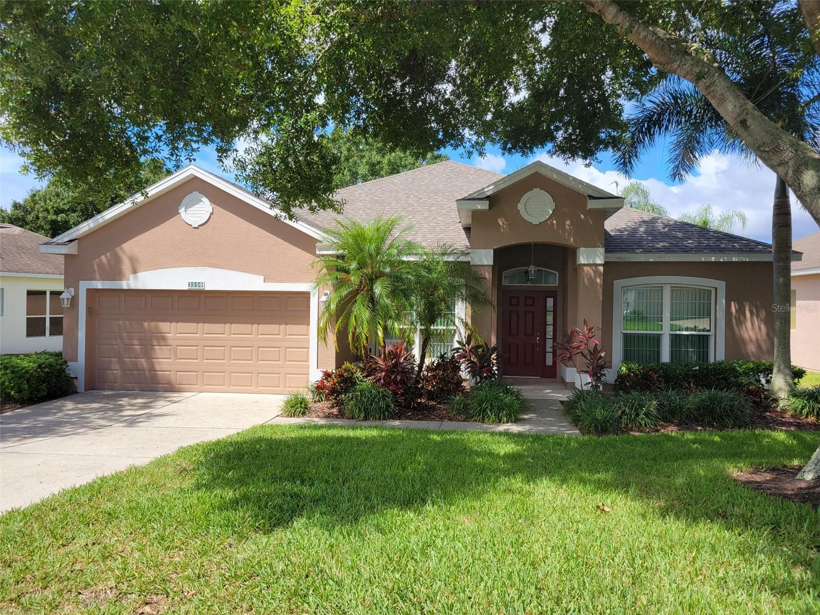 Magnificent home in highly sought-after 55+ Kings Ridge. Enjoy the awesome sunsets on the West facing Lanai that overlooks the 14th fairway of the golf course and pond with a beautiful water fountain. This lovely St Clair model boasts three spacious bedrooms and two baths with 1922 square feet of living space. Entering the home at the foyer features the Dining Room on the left and Family Room on the right. The large Living Room is off the gourmet kitchen with sliding door access to the oversized 29 x 18 screened covered lanai. Home includes a 2 car garage with door opener, utility sink and water softener. Interior laundry Room. All appliances are included in the sale, except for the Washer & Dryer. Seller is including the Dining Room Table, Chairs and Buffet if desired by the Buyers. Enjoy the safety of a guard gated community and beauty of tree lined streets and amazing community amenities including a multi-million-dollar clubhouse. Live the Royal lifestyle with two 18-hole golf courses, three heated pools, two fitness centers, spas, tennis & pickle ball courts, billiards, shuffleboard, shows, Bingo, Dancing, cards, crafts, movie & food truck nights and join any one of the many clubs galore. HOA dues include lawn maintenance & irrigation, exterior painting, landline phone, basic cable and internet and all community amenities. Close to Highway 27 and 50, Florida Turnpike with easy access to downtown Orlando within 30 minutes & twenty-two miles to Disney. Conveniently located outside the community: golf cart accessible Publix, University of Florida urgent care center, doctors, dentists, Walgreen’s pharmacy, Quest and close to Costco, Kohls, Walmart, BJs and numerous restaurants within five miles. At least one buyer must be at least 55 years old or older for HOA approval. Age of Items: New Roof - Nov 2024; New Complete Lennox HVAC Unit - Oct 2023; New Water Heater - Oct 2023; Exterior Paint - Oct 2022; Energy Efficient Pella Windows & Sliding Glass Doors - 2017; Upgraded Flooring - 2017. Call for a private tour of this fantastic home.
