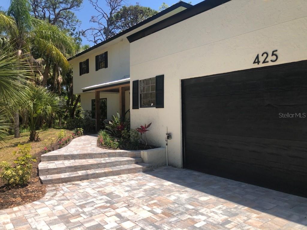LUXURY. LOCATION. LIFESTYLE. This stunning, fully renovated 5-bedroom, 3.5-bathroom home offers over 3,000 sq ft of stylish living space, thoughtfully designed for both everyday comfort and high-end entertainment. Set on a private, wooded ¾-acre lot, this peaceful retreat has NO HOA, HIGH AND DRY-NO STORM DAMAGE, and public water already installed—all in a highly desirable location just minutes from the Gulf, Nokomis Beach, marinas, and shopping.
Every inch of this home has been meticulously upgraded with New Metal Roof, HVAC systems, electrical, plumbing, irrigation. All luxury upgrades inside home is Luxury Vinyl Plank Flooring, Kitchen, Bathrooms, Closets, and Paint, ensuring a true move-in-ready experience with peace of mind. The open-concept floor plan invites you in with a spacious living room, architectural wood-accented dining area, and an Elegant and spacious Great Room featuring a built-in electric fireplace—all highlighted by luxury vinyl plank flooring, stylish lighting, and designer finishes throughout. French doors off the dining room lead to a charming brick patio with plenty of space to create your dream pool or outdoor entertaining space.
The heart of the home is a chef’s dream kitchen—complete with premium cabinetry, quartz countertops, built-in microwave/oven, stainless steel appliances, and a large waterfall-edge island perfect for gathering and entertaining.
The main-level Primary Suite is a versatile retreat with a walk-in closet behind barn doors, private wet bar, and luxe bathroom which you can either repurpose for your needs or making it ideal for a future pool bath if desired. Ensuite is conveniently connected to a spacious laundry room and the Great Room.
Upstairs, you’ll find a full In-Law Suite, complete with an oversized bedroom, office nook, large walk-in shower, walk-in closet, and private second-story deck—perfect for enjoying quiet morning coffee or sunset views.
Host with ease and welcome family and friends with 3 spacious guest bedrooms and a private In-Law Ensuite, all located on the second level—keeping the main-level Primary Suite your own personal retreat. This home is perfectly designed for entertaining and comfortable for all your guests.
Just minutes to shopping, beaches and marinas, this exceptional home offers the perfect blend of luxury living and Gulf Coast lifestyle.