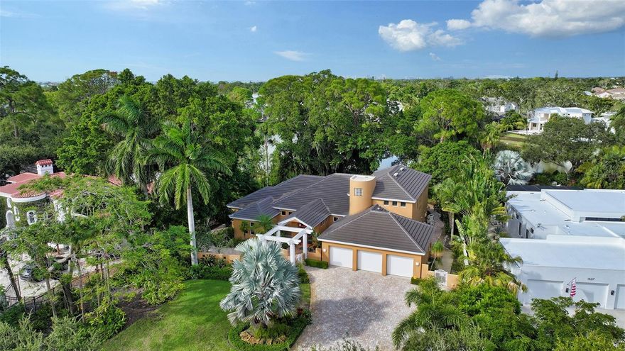 Beautiful lake front home in Oyster Bay on over half an acre with mature oak trees and luscious vegetation. You enter this custom 4300 square foot contemporary home through a lush private courtyard. Your attention is immediately drawn to the soaring ceilings that highlight the unique architectural features that emphasize the open feel, and beautiful views of the lake. A private entrance on the main floor leads to an oversized primary suite overlooking the lake.  Large walk-in closets and a spacious bath complete the primary bedroom.  An office is conveniently located near the primary suite. The kitchen has granite countertops, and light wood cabinets with an island, a large walk in pantry and breakfast nook. Off the kitchen is a screened lanai leading out to an open pool, large backyard, and lake. The beautiful pool area lends itself for great outdoor entertaining with beautiful lake views. The guest suites are upstairs with each bedroom having an en suite bathroom. A bonus room is upstairs as well. Surrounding the house are paver walkways. The property is fenced in, there’s a 3-car garage with a paver driveway and parking pad.  A new roof was added in 2019. Shopping, restaurants, and schools are close by, and the hospital is within 5 miles.  The award winning beaches of Siesta Key are minutes away. Come and take a look at this amazing property and put your own stamp on it to begin living your best life!