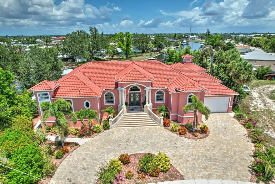 SEASONAL RENTAL- Turnkey Furnished Luxury Waterfront Estate.
Step into timeless elegance with this custom Tuscan-inspired masterpiece, where architecture and artistry unite against the stunning backdrop of Florida’s shimmering waters. From the moment you arrive at the circular paver driveway, framed by graceful marble columns and wrought-iron accents, this residence reveals itself as a sanctuary of sophistication and coastal grandeur.
Inside, 12+ foot ceilings crown expansive living spaces awash in natural light, while travertine floors and genuine marble columns exude enduring luxury. Walls of impact glass and French doors invite breathtaking water views at every turn. The gourmet kitchen is both refined and functional, boasting granite countertops, a table-height breakfast bar, stainless steel appliances, a six-burner LP stovetop, and built-in double ovens—all designed for the discerning chef.
A split floor plan ensures privacy, with spaces thoughtfully designed for both relaxation and entertainment. The residence includes a dedicated office, media room, and a generous recreation/bonus room, making it a true retreat for both work and leisure.
Step outside to discover expansive covered lanais, wrought-iron railings, and a resort-style 15’ x 30’ pool—all overlooking sailboat waters just 600 feet from Charlotte Harbor. With two private docks, each equipped with boat lifts, enjoy direct Gulf access within minutes.
For the car enthusiast, a four-car garage with front and rear overhead doors provides convenience and storage, while multiple French and pocket doors seamlessly blend indoor and outdoor living.
Beyond the property, the magic of the Florida coast awaits. Explore the vibrant energy of Fisherman’s Village, indulge in world-class dining at the Sunseeker Resort, or embark on a boating adventure to countless waterfront destinations. Shopping, entertainment, and cultural experiences are always within easy reach.
This home embodies unparalleled luxury, convenience, and connection to the sea—a rare offering that captures the essence of the Florida lifestyle.
Call today to arrange your private tour and experience waterfront living at its finest.