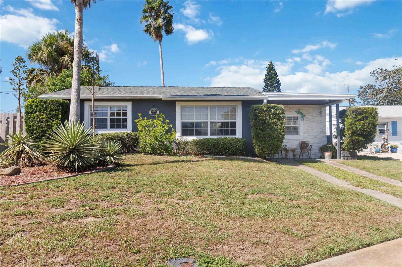 Remodeled coastal gem nestled close to the beach on desirable Seaside Drive. This inviting beachside home blends modern updates with laid-back coastal charm. The heart of the home is the beautifully renovated kitchen featuring a farmhouse sink and an open dining area that looks out to the fenced backyard and patio that is set up perfectly for casual gatherings or quiet evenings under the stars. The split layout offers two bedrooms and a full bath on one side, while the spacious third bedroom with a private half bath sits on the opposite side, ideal for guests, a home office, or a flex space. The spa-inspired full bath is highlighted by a full-body spray shower system for an at-home retreat feel. Meticulously maintained and thoughtfully improved, recent updates include a brand new roof (Dec 2023), new primary bedroom flooring (Nov 2024), new washer and dryer (Apr 2025), new disposal (Mar 2024), and septic pumped (Nov 2024). Regular pest control, lawn care, and HVAC maintenance ensure this home is ready. Just around the corner, Tom Renick Park offers oceanfront picnic shelters, showers, and a beach access point, while the Halifax River pier is only a short stroll away. Furnishings are available, making this the perfect turnkey coastal getaway or year-round home in Ormond-by-the-Sea. Mortgage savings may be available for buyers of this listing.