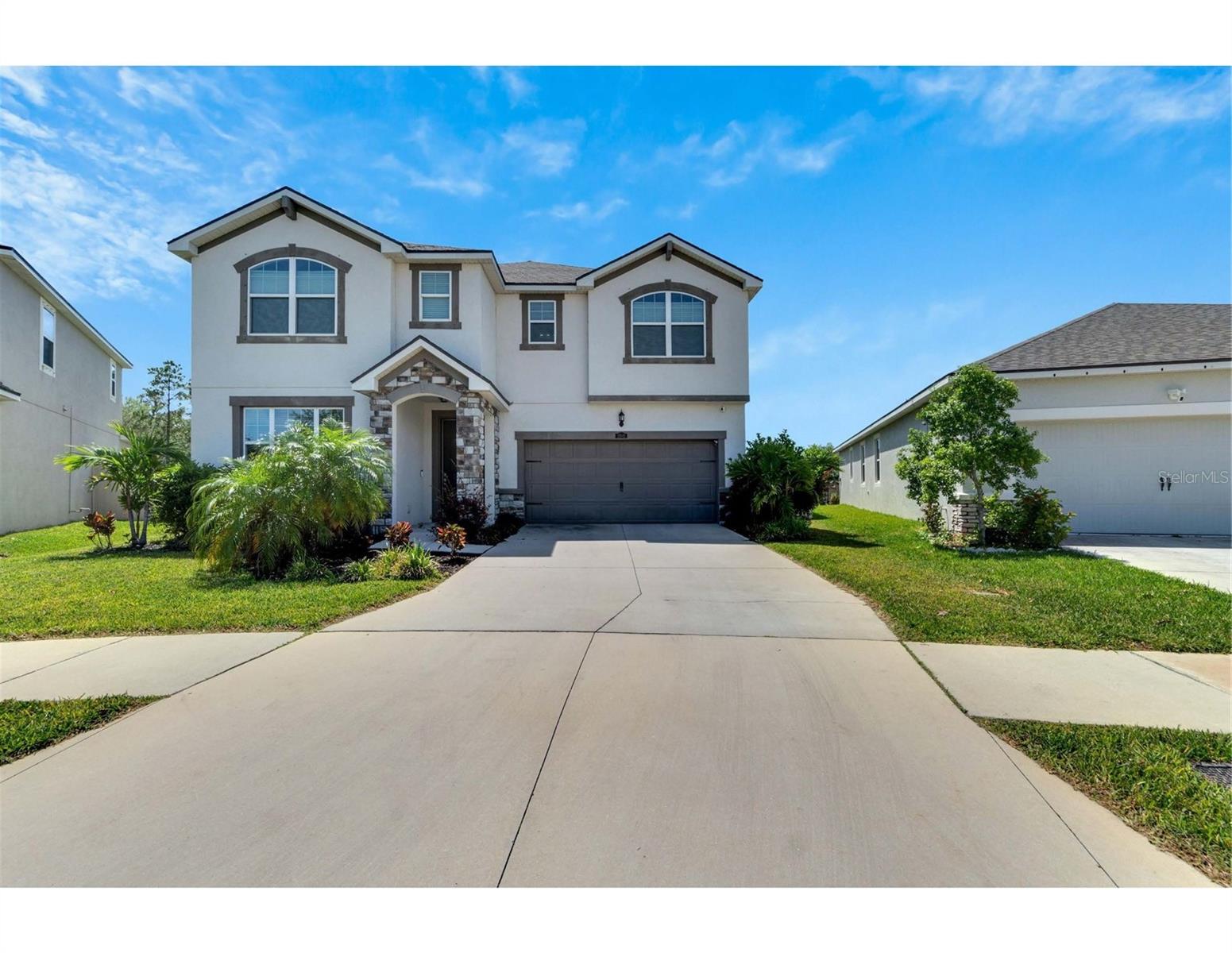 Two-story single-family home in the resort-like Boyette Park Community! This French Country style home features 5 bedrooms and three baths. Kitchen is a knock-out with upgraded 42" upper cabinets in Tahoe Cherry Slate with Crema Pearl granite counter tops. Microwave is vented outside. Walk in pantry gives you plenty of storage and grocery space. Kitchen also has a breakfast bar and it opens up to the eating area. Sliders open out onto your oversized lanai. The huge family room is adjacent to the kitchen and eating area. First level also features a dining room and a bedroom and full bath that would make a great in-law suite or guest suite. Legacy plank 7x22 tile covers your main living areas. Follow the stairs up and you will find the master suite and three secondary bedrooms with a loft that has brand new flooring! Tray ceiling and two walk-in closets are the top two features of the master suite as well as a walk-in closet in the bathroom. Good sized secondary bedrooms share a hall bath and has a loft that is perfect for secondary living area. The very large backyard and covered lanai is ready to entertain - could even add a pool with all the space. Landscaping has just been updated. The Solar offers next to nothing electric bills which is a HUGE bonus. Close to excellent dining, shopping, recreation and easy access to the Freeway. No Flood Zone and Low CDD/HOA Fees. With over 2900 sq ft of living space, this home is waiting for its perfect owners.
