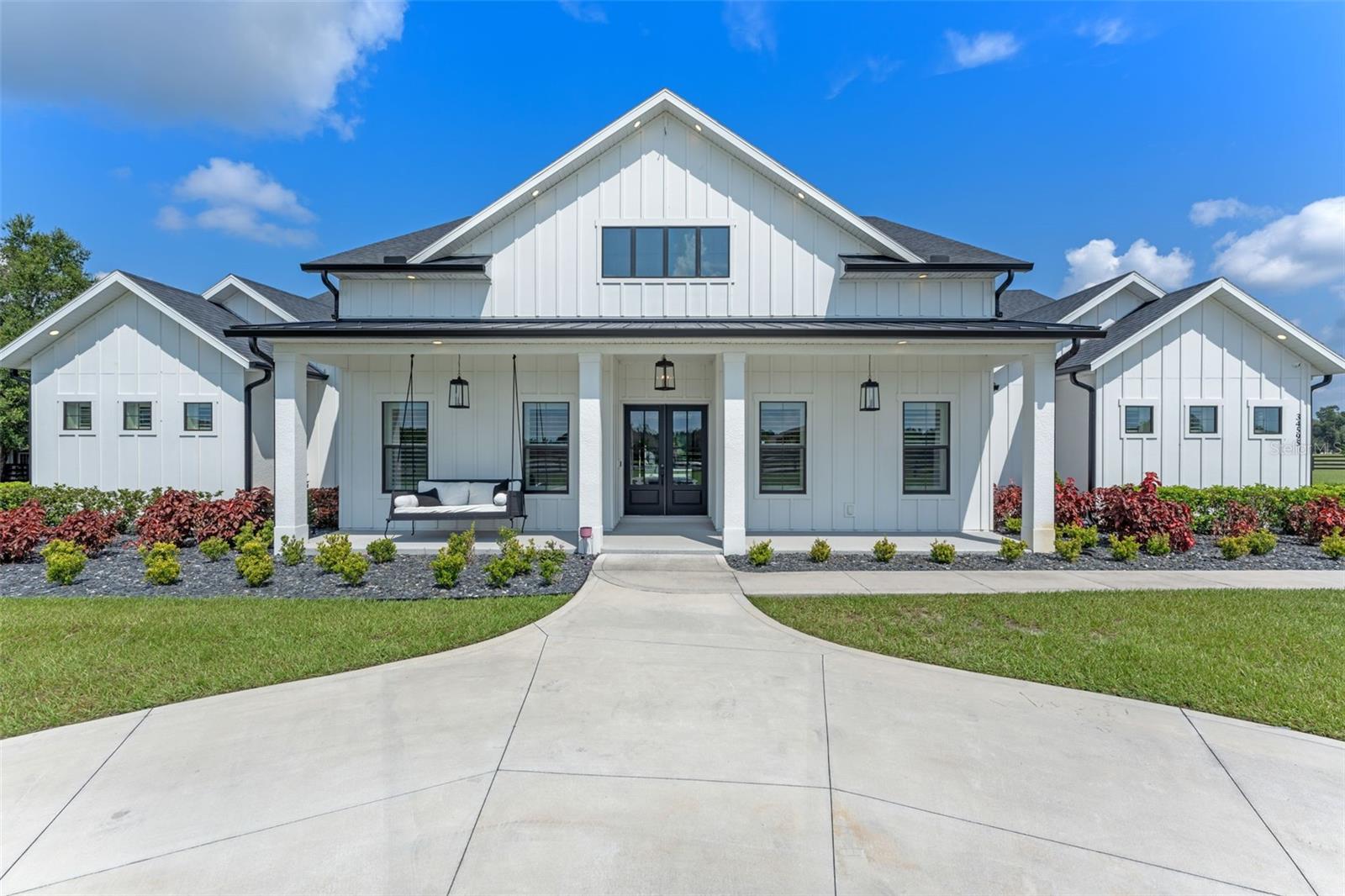 One or more photo(s) has been virtually staged. Built in 2022, this stunning 4-bedroom, 5-bathroom custom home offers luxury living on a private 3.77-acre lot in the highly sought-after equestrian community of The Reserve at Lake Seneca. Located in the heart of East Lake County, this exceptional residence combines country serenity with urban convenience, offering easy access to shopping, dining, and recreation, plus a short commute via the brand-new 429 expressway to Orlando attractions, historic downtown Mt. Dora, and much more. Inside, every detail has been thoughtfully designed with modern features and elegance throughout. Each of the four bedrooms includes its own ensuite bath, while additional bonus spaces elevate the home’s versatility. These include an office with a closet that can serve as a fifth bedroom, a private theater room, a wine room, and two mudrooms. The chef’s kitchen boasts a hidden pantry tucked seamlessly behind custom cabinetry, providing both style and function. The living areas showcase contemporary finishes, an electric fireplace, and a whole-home Sonos speaker system. A 5-car garage with Smart Racks and a whole-house generator add to the comfort and convenience. Step outside to a resort-style lanai that fully encloses for hurricane protection and overlooks a heated saltwater pool with an 8-foot deep end. The outdoor kitchen, gas line for pool and grill, and spacious entertaining areas make this home ideal for gatherings year-round. The property itself is fully fenced with a gated entrance and includes a barn with two stables, an automatic watering system, a tack room, and additional storage with a garage door for farm equipment. Zoned for horses and chickens, this estate is perfect for those seeking both luxury and a lifestyle property. The Reserve at Lake Seneca, a premier 113-acre gated community with just 24 home sites, offers residents access to a private boat ramp on beautiful Lake Seneca for boating and fishing. Don’t miss the opportunity to own this extraordinary estate that blends elegance, comfort, and functionality in one of Central Florida’s most exclusive equestrian communities!