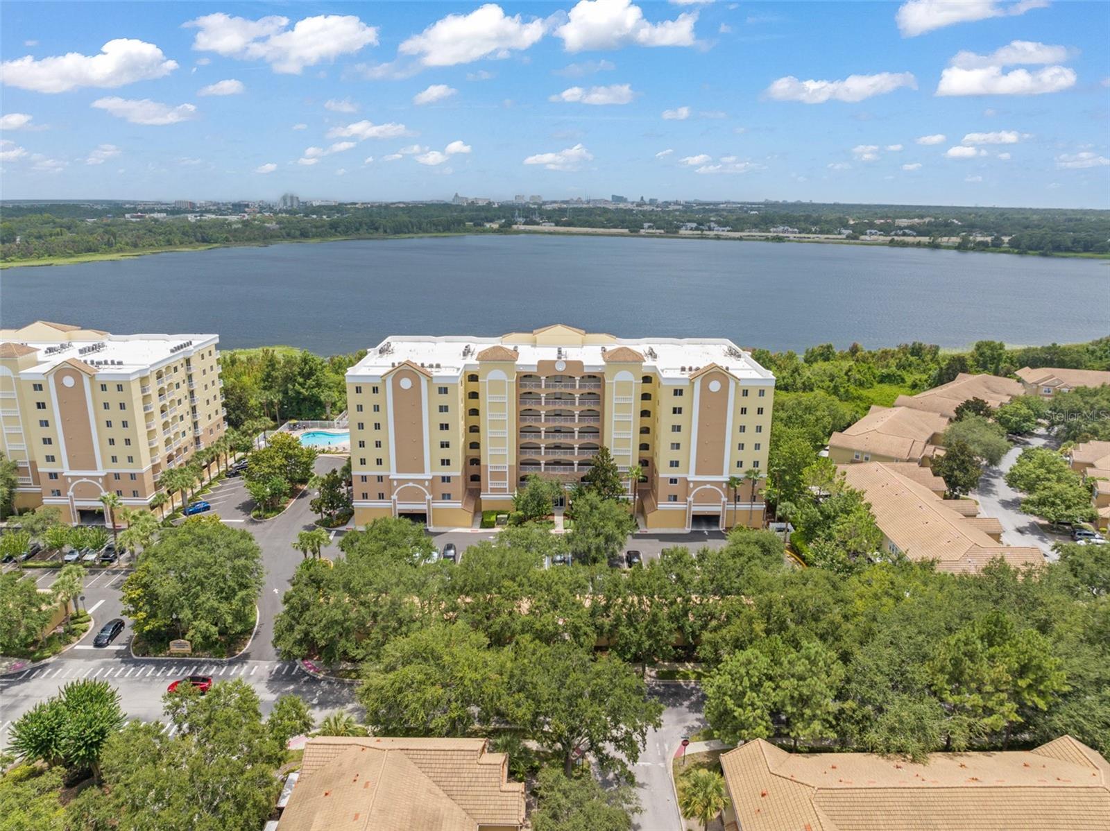 Top-floor penthouse unit with spectacular water views! This is a rare opportunity to take advantage of the best views in MetroWest. This sparkling clean and neutral 3-bedroom unit has just been freshly painted and overlooks the 323-acre Turkey Lake, offering sunset and fireworks views from both of your private balconies. Master bath offers double closets with custom-built barnyard doors, dual sinks and jetted tub along with separate shower – complete with new fixtures, lights, and treated cabinetry. Upgraded kitchen features 42” cabinets, stainless appliances, and Corian countertops. Double secure community with gated subdivision and code required front lobby entrance. Monthly HOA dues include basic cable, water and trash, 24-hr gate access security camera intercom, one covered assigned parking space, plus access to the fitness center, community social room and more. Ideally located minutes from Universal Studios, SeaWorld, and Walt Disney World.