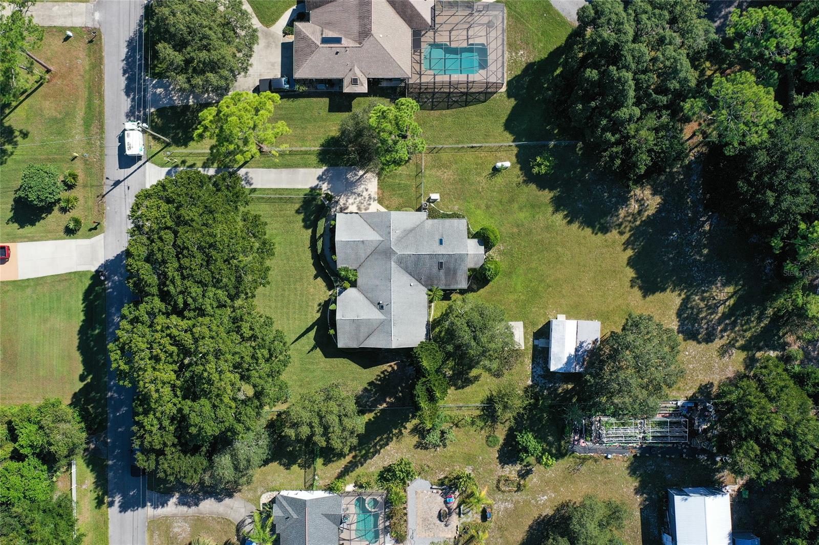 Looking for a HOME on LAND in Port Orange with no HOA? Check out this large 6 Bedroom, 5 Full Bath home on just under ONE ACRE! Split floor plan with almost 2900 living square & loads of Potential! Large bedrooms! Most baths have been updated with tiled walk in showers. One bedroom & bath has its' own private entry, perfect for extended family or use as a rental! Beautiful piece of property with a long driveway, distinguished Oaks, Quiet street. Plenty of room to add a pool or metal building! Area restaurants & shopping nearby! Minutes to Port Orange's preferred schools! 15 minutes to the beach! Included Features: Fenced Yard, Full House Propane Generator, Updated Electric Panel, Impact Windows, Hard Wired Interior/Exterior Security Cameras, Two A/C's, Two Septic Systems, 2 Storage Sheds. ;Water: City