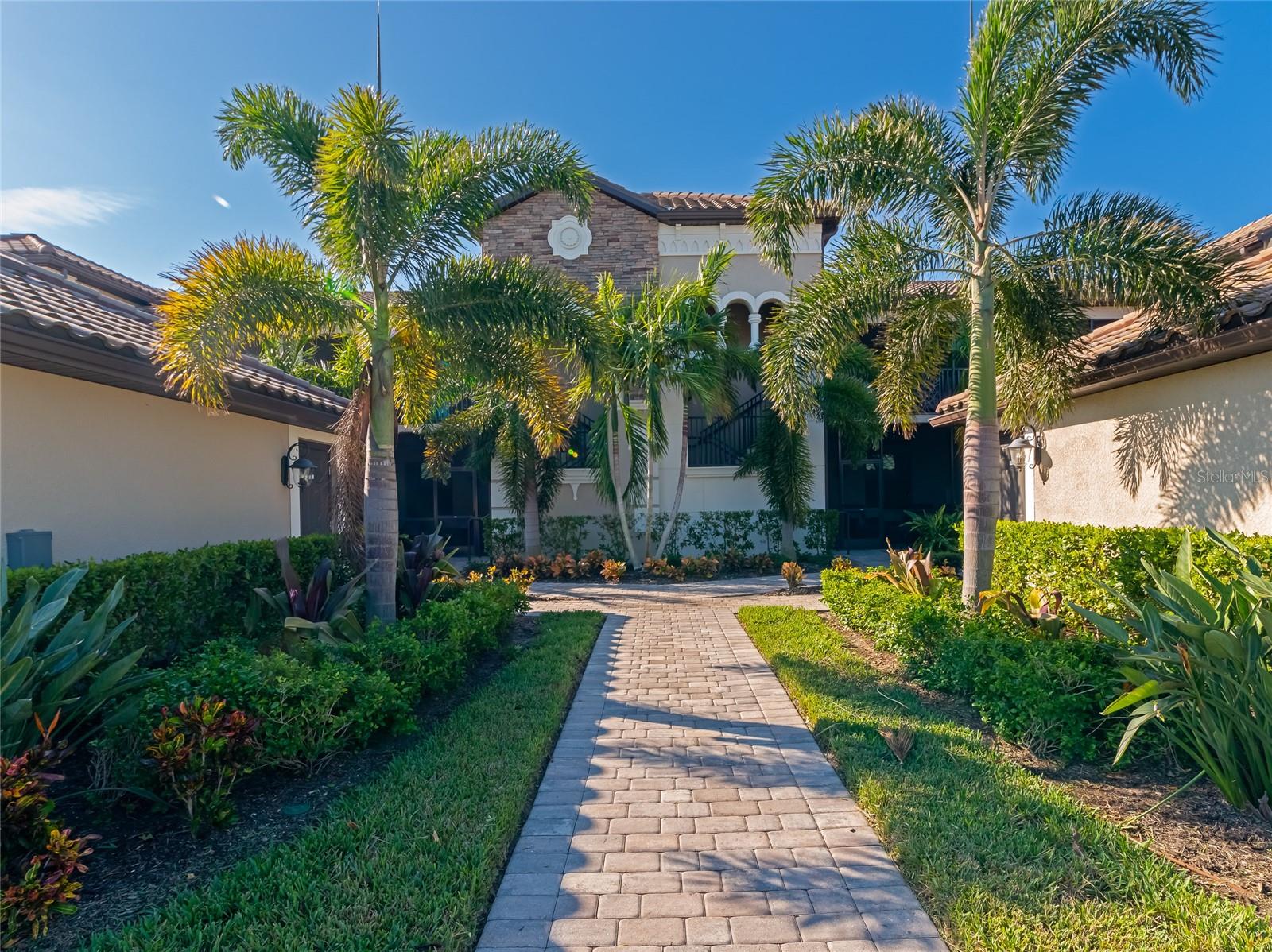 If living the Florida golf lifestyle is on your horizon, you won't want to miss the opportunity to view this turnkey furnished condo in the gated community of Lakewood National. As you approach the ground floor unit, a tasteful enclosed patio welcomes you and your guest and is perfect for entertaining or relaxing after a challenging round of golf. Once inside, the water views offered by the living room's sliding door draw you to the second screened patio, which is a perfect spot to sit with your favorite beverage to watch the wildlife come and go or catch a winter sunset sinking over the 9th hole of the Commander course. The open-concept kitchen is well-appointed with granite countertops, stainless steel appliances, and a breakfast nook & bar top seating for informal gatherings & dining. The carpeted primary bedroom is graced with ample closet space and an ensuite bath with a dual sink vanity & walk-in tiled shower; With a convenient laundry closet located just outside its entrance. Top it all off with a guest bedroom & full bath, a bonus space ideal for a home office, and an assigned garage & guest parking... You'll see that this place has it all! The Veranda condominiums have maintenance-free living with extraordinary amenities - including a full golf membership to play the two nationally recognized 18-hole courses designed by Arnold Palmer, a zero-entry heated pool with cascading waterfalls and lap lanes, poolside Tiki bar and café, a 24 hours fitness center with group exercise classes, an on-site full-service spa, eight lighted Har-Tru tennis courts, bocce, pickleball, several satellite pools, and more. Lakewood National is situated in the heart of Lakewood Ranch, the No. 1 planned community in the U.S., which encompasses 50 square miles filled with dining, arts, entertainment, shopping, nature & recreation, and A-rated schools. What's more, its easy access to I-75 makes it an easy commute to enjoy everything offered in Downtown Sarasota, Bradenton, or Tampa, and a breeze to spend the day lounging in the sand and warm gulf waters of the area's world-renown beaches on Siesta Key, Lido Key, and Anna Maria Island.