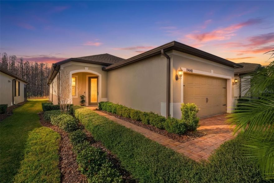 Welcome to resort style living in Del Webb Bexley, a gated 55+ community in Land O’ Lakes! Located at 19440 Ship Wheel Way, this beautifully upgraded Pulte-built Steelcreek floor plan offers 2 bedrooms, 2 bathrooms, and a 2 car garage, perfectly designed for comfort, convenience, and low-maintenance living. This thoughtfully appointed home features an open-concept layout filled with natural light and enhanced by numerous upgrades completed since purchase. The kitchen is equipped with new upgraded stainless steel appliances, including a refrigerator, stove/oven, microwave, and dishwasher ideal for everyday living and entertaining. Both bathrooms have been elevated with smart toilets featuring heated seats and full bidet functionality, adding a touch of luxury. The primary suite includes a custom Closets by Design system, maximizing storage and organization. Enjoy peace of mind and improved water quality with a whole home water filtration system and water softener. The garage has been transformed with Shark Tech flooring and built-in cabinetry, providing a clean, functional, and polished space. Step outside to the screened patio with sun shades, perfect for relaxing year-round, and enjoy the added pavered area just beyond the porch, ideal for outdoor seating or grilling. Del Webb Bexley offers an exceptional lifestyle with world class amenities, including a clubhouse, fitness center, pools, pickleball, walking trails, and a full calendar of social activities. Conveniently located near shopping, dining, and major roadways, this move-in-ready home combines upscale upgrades with an active adult community lifestyle. Don’t miss your opportunity to own this upgraded Steelcreek home—schedule your private showing today!