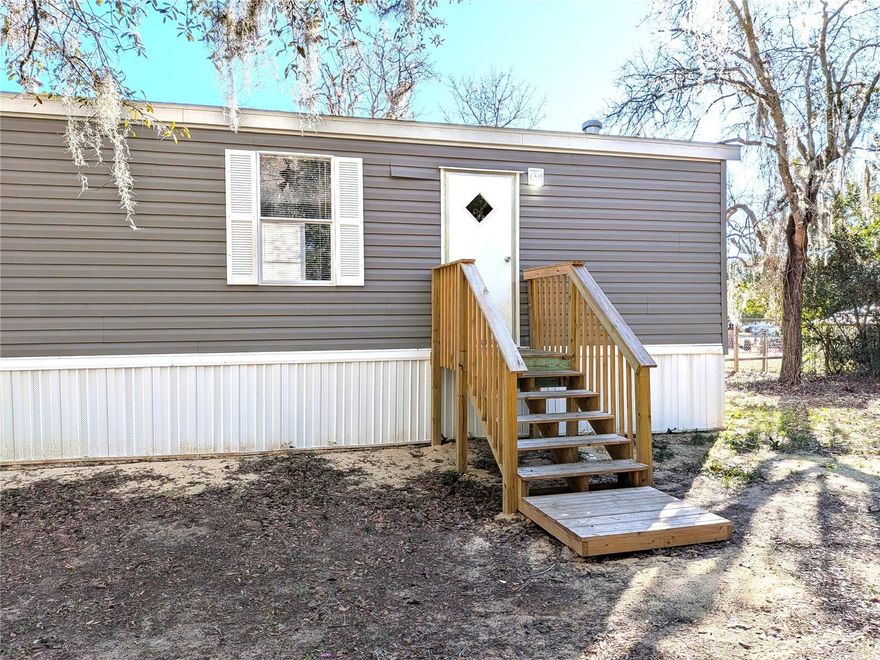 Adorable 2 bedroom, 2 full bath singlewide completely refurbished offers 896 sq. ft. of living space on a 0.19-acre lot, providing a peaceful setting in the desirable Circle M Ranchettes community. The split bedroom design provides privacy, with a primary with end-suite on one side and a guest bedroom/nursery/office on the other, with an attached bath. Master bedroom features a generous sized walk in closet. Living room/kitchen/dining room open concept great for entertaining. Yard fully fenced with a 8 x 20 storage container for all your storage needs. Conveniently located near shopping, dining, popular outdoor activities like boating and bass fishing on Lake Rousseau, tubing down the Rainbow River, just minutes from some of Florida’s most sought-after natural springs, and kayaking the Withlacoochee River. No HOA, no lot rent and NO flood zone! Don't miss this opportunity, schedule your showing today!