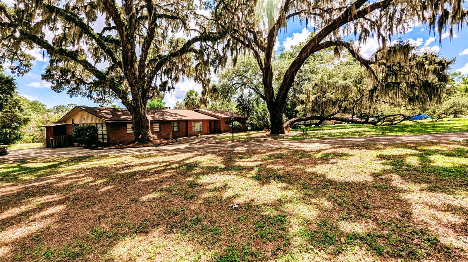 Charming Fully-Furnished Brick Rambler on Canal – Secluded, Turnkey & All-Inclusive!
Welcome to the Arched Oak Property located in Miona Lake Estates, a beautifully maintained, One-Story, 2-Bedroom, 2.5-Bath, 3000 SqFt Brick Rambler, nestled in a peaceful neighborhood, just outside The Villages in Wildwood, Florida. Perfectly situated on a tranquil canal with beautiful wildlife and excellent fishing right in your backyard, this home offers comfort, convenience, and serenity. Enjoy the seclusion and tranquility of a peaceful, shaded setting—while being just minutes from all the shopping, dining, golf, and entertainment The Villages has to provide—without the restrictions or fees of being inside The Villages.
This fully furnished home is truly turnkey and offers a thoughtfully designed layout, including:
Formal Living and Dining Rooms for entertaining
A Family Room for everyday relaxation
A Bright Eat-In Kitchen with refrigerator, electric range, microwave, dishwasher, pantry & ample cabinet space
A Spacious Primary Suite with Private Bath, Walk-In Closet and Ceiling Fan
A Guest Bedroom with Ceiling Fan and second Full Bath
A convenient Half Bath for guests
Full-Size Washer and Dryer for in-home laundry convenience
Step outside to your Private Patio overlooking a peaceful canal filled with fish and surrounded by Florida wildlife, a perfect spot for morning coffee, afternoon lunches, or evening relaxation.
Included Amenities:
Electric
Central HVAC (Cooling and Heating)
Water Heater
High-Speed Internet
Security System
Well water with Whole-House Filtration and Softener
Septic System
Lawn Care and Exterior Maintenance
Additional highlights:
Sits on 1 Acre of Land with Beautiful Live Oaks and Palm Trees
Well-shaded lot ideal for relaxation
Pet-Free and Smoke-Free environment
New roof for peace of mind
Quiet and secluded location right next to The Villages—enjoy the best of both worlds!
This fully furnished rental offers exceptional value in a serene setting—perfect for seasonal residents or traveling professionals that are looking for a stress-free lifestyle in a peaceful, natural environment with unbeatable access to amenities. Don’t miss this rare opportunity!