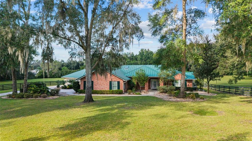 No HOA, Home comes furnished- Move in ready! Escape to serene equestrian living in this beautifully maintained Southeast Ocala property set on more than 4 tranquil acres in the sought-after Turning Hawk Ranch community. Surrounded by grand oak trees and secured by fencing and a private gate, this property backs directly to the Florida Greenway—perfect for trail rides or peaceful nature walks. Home is complete with 3 full bedrooms and 3 full bathrooms- Two Den/Offices areas- one of the Dens could be converted into a 4th bedroom. 

Inside, the single-story home welcomes you with an airy, open layout featuring vaulted ceilings, elegant porcelain tile floors, and an abundance of natural light streaming through skylights. The spacious living room centers around a stunning gas fireplace, creating a warm and inviting atmosphere. The chef’s kitchen offers generous cabinetry and counter space, premium JennAir stainless appliances, a center island with cooktop, and a well-organized pantry.

The owner’s suite is a true retreat, complete with a walk-in closet and a luxurious bath that includes dual sinks, a walk-in shower, and a soaking tub. Two additional bedrooms, each with their own private baths, offer comfort and flexibility for guests or family. The home also includes a dedicated office or den, wet bar, and a formal dining area—ideal for entertaining.

A breezeway connects to the detached two-car garage for convenience, while the expansive back deck and paver patio provide perfect spots for gatherings or quiet evenings under the stars.

Equestrians will love the 4-stall concrete barn, thoughtfully designed with matted stalls, automatic waterers, wash racks, a tack room, and covered equipment storage. The paddocks are securely fenced and dotted with shade trees, making it ideal for horses of any discipline.

Located just minutes from the Florida Horse Park and a short drive from downtown Ocala’s shopping and dining, this private estate combines comfort, functionality, and the equestrian lifestyle at its best—without the restrictions of an HOA.