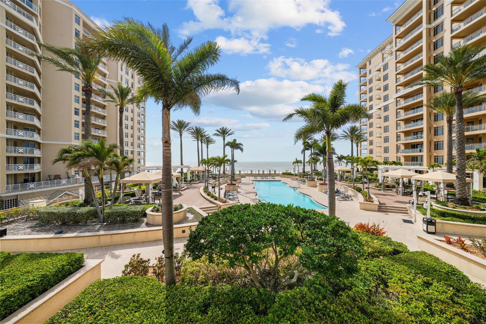 Step into paradise at this stunning, fully furnished coastal condo, ideally situated on the world-famous white sands of Clearwater Beach. This bright and spacious two-bedroom, two bathroom residence boasts breathtaking beach views and a thoughtfully designed open-concept layout featuring a gourmet chef’s kitchen and an expansive family room. Slide open the glass doors and step directly onto the sprawling resort-style pool deck, where a large heated pool and spa await—perfect for soaking up the Florida sun just steps from your door. Nestled within the exclusive, gated Sandpearl Residences, this pet-friendly beachfront resort by JMC Communities offers 700 feet of sugar-white Gulf shoreline, along with exceptional amenities including 24-hour concierge service, secured garage parking, and a fully equipped state-of-the-art fitness center to keep your wellness routine on track. Located in the heart of Clearwater Beach, you’ll be just a short stroll from Pier 60, vibrant dining, boutique shopping, and endless entertainment. Whether you're here to unwind or explore, experience the very best of luxury coastal living.