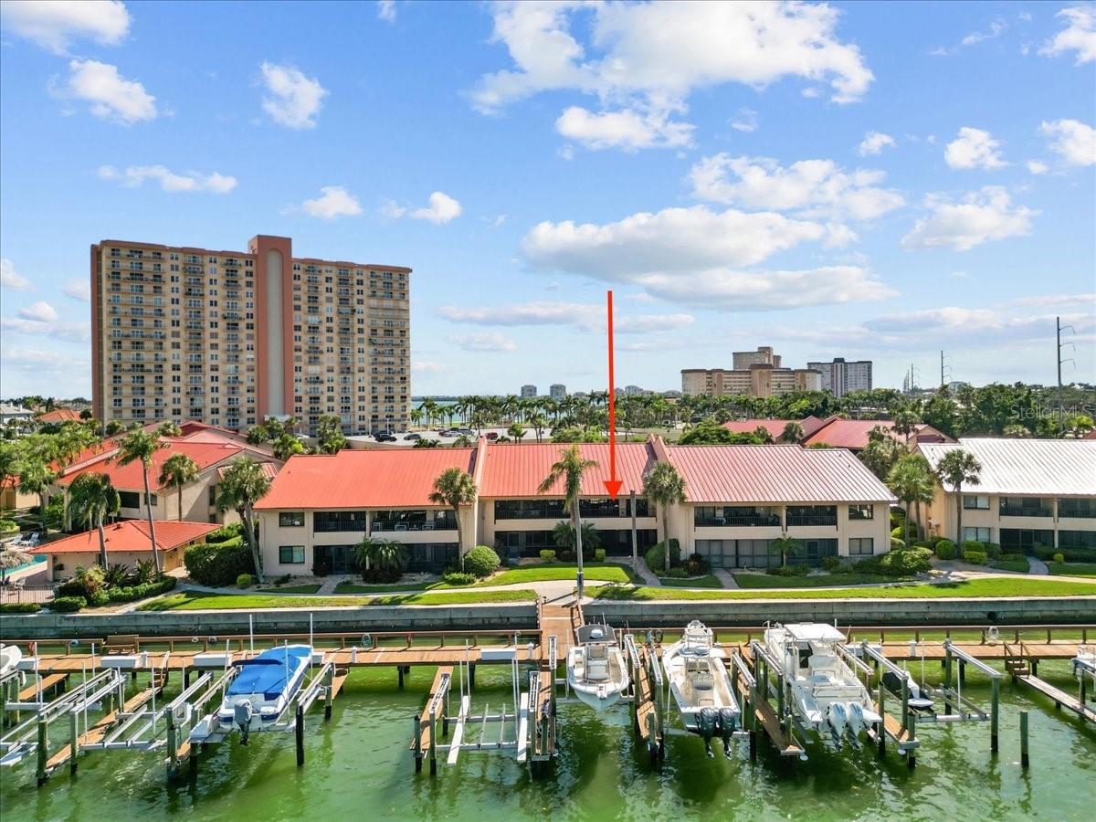 Experience Iconic Waterfront Living, Fully Renovated Coastal Condo with DEEDED 12,000 LB BOAT LIFT + PRIVATE 1-CAR GARAGE. This is a NON AGE RESTRICTED COMMUNITY- All ages welcome. Ask about SELLER FINANCING options.
Welcome to a waterfront lifestyle that checks every box, boater’s dream, turnkey luxury, and income potential all wrapped into one stunning residence. Perfectly positioned just minutes from the open Gulf, this rare opportunity offers effortless access to Florida’s most iconic sandbars, world-class fishing, and destination dining, no bridges, no hassle, just dock and go.
Built high and dry, even first-floor units stayed untouched during past storms—peace of mind during hurricane season is already part of the package.
Inside, no detail has been overlooked in this full-scale renovation. Every surface, finish, and fixture has been thoughtfully curated to elevate your everyday. Whether you’re searching for your personal paradise or a high-performing investment, this unit delivers, complete with 12-times-per-year rental flexibility and the option to purchase furnished.
Wake up to sparkling water views from the primary suite and wind down with dolphins playing in the channel—this is coastal serenity, redefined.
The open-concept living area blends modern comfort with elevated style, anchored by a built-in electric fireplace and oversized sliders that lead to an extra large private balcony.
In the heart of the home, the chef’s kitchen stuns with luxury granite countertops, stainless appliances, a custom island, and dual beverage fridges built into a sleek storage wall—ideal for entertaining or winding down in style.
Retreat to your waterfront primary suite featuring a designer walk-in closet and a spa-worthy en suite bath. A spacious second bedroom and full guest bath offer comfort and privacy for visitors.
A true rarity: your private epoxied 1-car garage with pull-down attic storage, plenty of space for beach gear, fishing equipment, paddleboards, and more.
Enjoy the feel of a high-end resort without ever leaving home, thanks to one of the area’s largest waterfront pools and spas, outdoor grilling stations, and lush tropical landscaping.
No outstanding assessments and a brand new standing seam aluminum roof (2025) already in place. Just 5 minutes to St. Pete Beach and 10 minutes to vibrant Downtown St. Pete, this is more than a home—it’s your front-row seat to the Florida