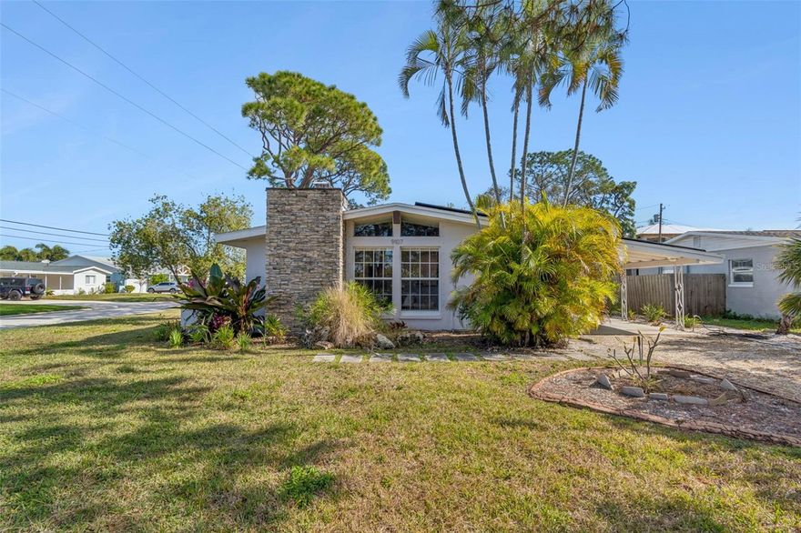 SPECTACULAR MID-CENTURY MODERN IN RIVIERA BAY. Welcome home to this completely and beautifully remodeled masterpiece where style meets sustainability. This MOVE-IN READY gem features FULLY PAID SOLAR PANELS, offering true energy independence with electric bills averaging under $40/month. Step inside to an atmosphere of airy elegance, defined by SOARING CEILINGS WITH EXPOSED WOOD BEAMS and a cozy brick fireplace that anchors the living space. Oversized windows beautifully illuminate the room with natural light, creating a seamless view of the tropical landscaping. The heart of the home is the COASTAL-CHIC KITCHEN, designed for culinary adventures with efficient modern cabinetry, shimmering mosaic backsplash, brand new stainless steel appliances and premium finishes.

The split plan offers ultimate privacy, highlighted by a LUXURIOUS PRIMARY SUITE. This retreat features a custom-designed CALIFORNIA CLOSET and a spa-inspired ensuite bath with double sinks and a frameless glass shower bathed in morning light. Emphasizing the Florida lifestyle, the two additional bedrooms open directly onto a TRAVERTINE-PAVED SCREENED PATIO, perfect for evening relaxation. EXCEPTIONAL UPGRADES include a tankless water heater, a minisplit in the laundry room, a brand new wood fence, and new French doors leading from the versitile garage/workshop to the luscious tropical garden. This is more than a home, it is a lifestyle.  

Years for the major systems and improvements: Electrical panel and minisplit (2023), Impact windows in the bathroom (2023), California closet and laundry room (2023), Aluminum Shutters for the front windows (2024), HVAC (2025), Sliding doors (2024), Roof (2017), Solar panels (2021), Wood Fence (2024), all kitchen appliances (end of 2024).