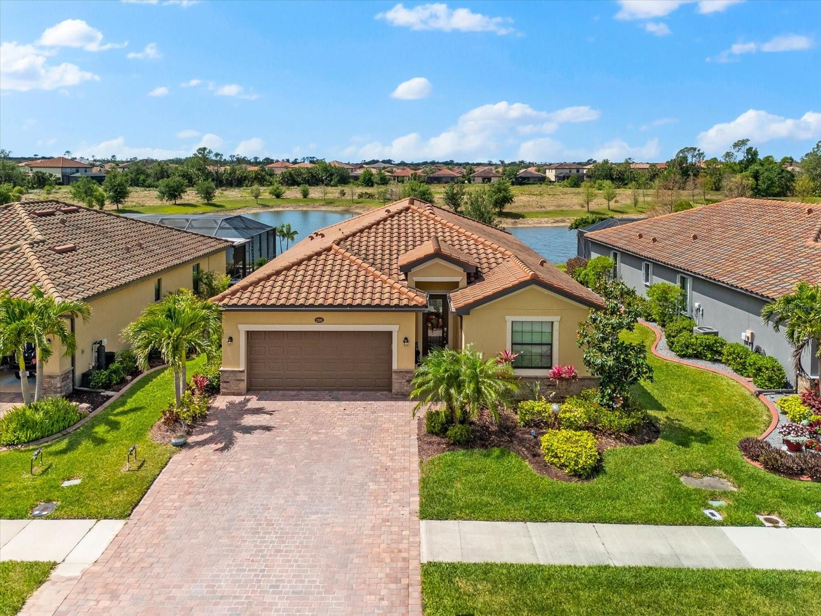 Welcome to your dream home in Gran Paradiso, one of Venice’s most luxurious and amenity-rich gated communities. This elegant 4-bedroom, 3-bathroom residence with a private heated pool and spa captures the essence of the Florida lifestyle. Whether you're looking for a peaceful retreat, a spacious family home, or a place to entertain in style, this property delivers.
From the moment you arrive, the home impresses with its manicured landscaping, paver driveway, and architectural details that enhance its curb appeal. The 2-car garage offers ample storage space and convenience.
Inside, you’ll find a thoughtfully designed open floor plan filled with natural light. Large windows and sliding glass doors frame tranquil views of the lanai and pool, while high ceilings, and neutral tile flooring throughout the main living areas create an elevated, cohesive atmosphere.
At the heart of the home is the chef’s kitchen, complete with stainless steel appliances, granite countertops, rich wood cabinetry, a large center island, and a walk-in pantry. It’s perfectly positioned for daily living or hosting gatherings, with both a cozy breakfast nook and a formal dining area nearby.
The spacious living room seamlessly connects to the outdoor area, where oversized sliding doors lead to a covered lanai and a screened-in pool and spa. Whether you're sipping your morning coffee poolside or enjoying an evening cocktail under the stars, the ambiance is peaceful and private.
The primary suite is a true retreat, featuring private access to the lanai, and serene views of the pool and lush greenery. The spa-like en suite bathroom offers dual vanities, a soaking tub, a frameless glass walk-in shower, private water closet, and two generous walk-in closets with custom storage systems.
The home's three additional bedrooms provide flexibility for guests, family members, or home office needs. One guest bedroom includes its own private en suite bathroom, ideal for visitors or multigenerational living. The remaining two bedrooms share a beautifully appointed third bath with modern finishes.
Step outside to your private tropical oasis, where the heated pool and spa are surrounded by landscaping and overlook a beautiful pond. The paver pool deck offers plenty of space for outdoor dining, lounging, and entertaining.
Additional features include:
Smart-home technology for modern convenience, hurricane shutters for peace of mind, energy-efficient construction, spacious laundry room with utility sink and built-in storage, tile roof, irrigation system, and abundant closet space.
Living in Gran Paradiso means access to truly exceptional resort-style amenities, including a freeform community pool, state-of-the-art fitness center, elegant clubhouse, tennis and pickleball courts, sauna and steam rooms, scenic walking and biking trails, full calendar of community events and activities.
Gran Paradiso is ideally located near everything that makes Venice such a desirable place to live. You're just minutes from Wellen Park, Atlanta Braves Spring Training Stadium, Venice Island, with its historic downtown, boutique shops, and fine dining, the Gulf Coast’s stunning beaches and vibrant cultural scene. There is also top-rated healthcare facilities, golf courses, and nature preserves.