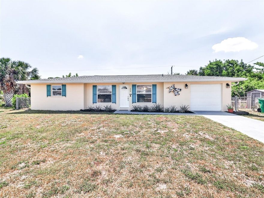 This charming 2-bedroom, 2-bathroom home with a 1-car garage is situated on a quiet street with a brand-new park at the end of the block and no neighbors on either side, offering a level of privacy that is rare for the area. The interior is move-in ready and features easy-to-maintain tile flooring throughout the entire home, along with a versatile Florida room that provides a bright and peaceful space to relax. The kitchen has been fully transformed with white shaker cabinets, quartz countertops, a subway tile backsplash, and stainless appliances. The primary bathroom is a designer standout, featuring boutique-style fish scale tile, a vessel sink, and a quartz vanity. The oversized, fully fenced lot is an outdoor retreat, complete with a shaded lounge area with string lights and a mature tropical "food forest" including three varieties of mango, mulberry, Jamaican cherry, hog plum, banana, and avocado. Buyers will have ultimate peace of mind thanks to significant upgrades including a new roof and gutters, a new Lennox Elite A/C system with new ductwork and blown-in insulation, a new electrical panel, new exterior doors, and replaced windows. For added security, the home includes hurricane shutters and has never flooded, providing essential protection and confidence. Located near local boat ramps, Gulf beaches, and shopping, this meticulously cared-for property is the perfect turnkey Florida retreat. Schedule your showing today!