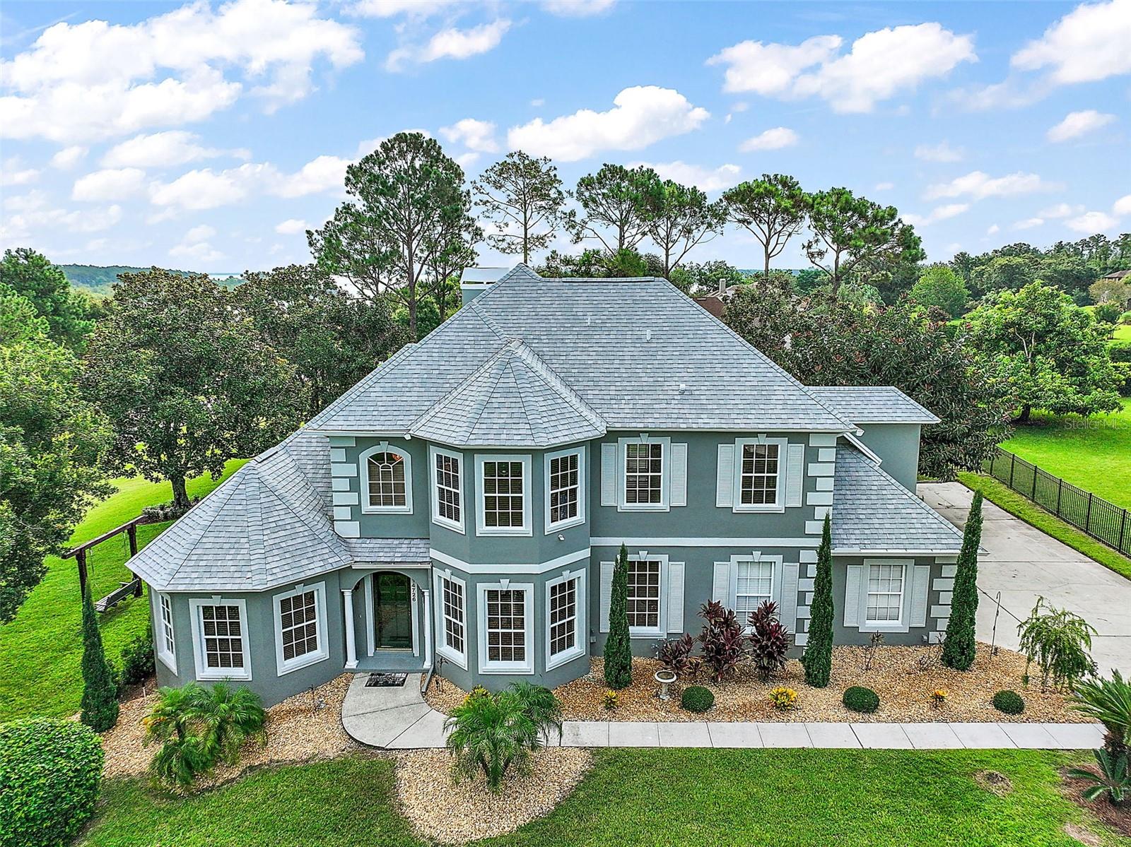 Welcome to Gourd Neck Springs – a private, gated waterfront community offering exclusive access to Lake Apopka via a resident-only boat ramp. Nestled on an oversized 0.69-acre corner lot, this true 4-bedroom, 3.5-bath home showcases stunning water views, a screen-enclosed pool, and a spacious layout tailored for comfort and entertaining.
As you step inside, you’ll be welcomed by soaring ceilings, crown molding, and oversized windows that flood the home with natural light. The open floor plan enhances the airy, elegant feel throughout the foyer and family room. To your right, an elegant formal dining room offers the perfect space for hosting, while to your left, a formal sitting area or office provides a quiet, light-filled retreat.
The primary suite, located on the main floor, features expansive views of Lake Apopka, a walk-in closet, and a luxurious en-suite bathroom with dual vanities, a jetted soaking tub, and a separate shower.
The kitchen is well-equipped with granite countertops, all-wood cabinetry, stainless steel appliances, a gas range, breakfast bar, and an inviting eat-in nook—perfect for both everyday meals and special gatherings.
Upstairs, you’ll find a junior suite with its own en-suite bathroom, plus two additional spacious bedrooms and another full bath.
One of the most valuable features of this home is the professionally installed automatic fire sprinkler system throughout - a rare and vital addition that provides peace of mind and enhanced protection for your loved ones.
Outdoor living is a true highlight of this property. The screen-enclosed pool is surrounded by a large, covered lanai featuring:
Newly installed epoxy flooring
A full outdoor kitchen and bar with a built-in grill and cooktop
TV and sound system hookups—creating an ideal space for indoor-outdoor entertaining
This move-in-ready home is just minutes from Montverde Academy, Bella Collina, and downtown Winter Garden, and is close to the West Orange Trail—perfect for walking, biking, or horseback riding. You'll also enjoy a quick commute to Orlando’s major attractions, downtown Orlando, and the international airport.