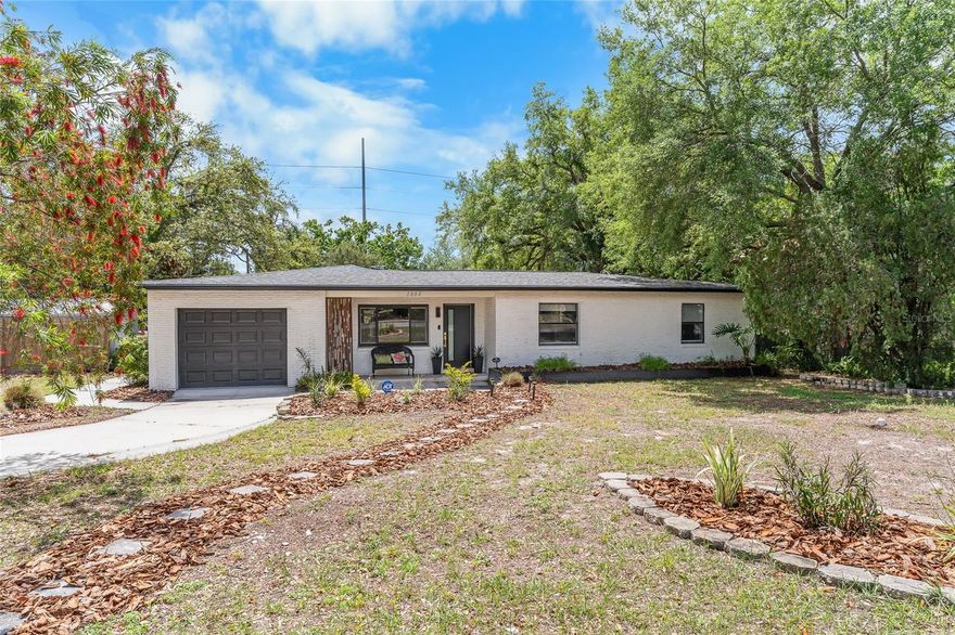 Discover this beautifully renovated 1958 mid-century modern home offering **1,801 sq ft** of bright, open living space on a rare **0.31-acre corner lot** in Tampa’s established Forest Hills neighborhood.
A fresh white-brick exterior, a sleek dark garage door, and vibrant tropical landscaping create outstanding curb appeal. The oversized corner lot features two side-entry driveways, ample parking (including room for an RV), and multiple sheds. The largest is wired for electricity and equipped with a wall unit, making it an ideal workshop or storage space.
Inside, the thoughtfully updated interior features light wood-look flooring, crisp white cabinetry, and modern finishes throughout.
The gourmet kitchen is a standout, featuring a large center island with a cooktop and seating, stainless-steel appliances, quartz countertops, and a bold patterned tile backsplash. It opens seamlessly to the living and dining areas, bathed in natural light through expansive windows overlooking the private backyard.
Relax in the spa-like primary bathroom, featuring dual vanities, a frameless glass shower, herringbone tile flooring, and elegant marble-like walls. Additional highlights include generously sized bedrooms and a screened lanai perfect for Florida living.

**Recent Upgrades Include:**
- HVAC system (2019)
- Roof (2020)
- Main sewer line replacement (2022)
- Well tank and pump (2022)

No HOA fees and not in a flood zone. 

This fully refreshed single-story home perfectly blends classic Florida charm with modern conveniences on an oversized lot ideal for outdoor entertaining, gardening, or future expansion. It is conveniently located with easy access to shopping, dining, and major roadways.

A true gem—move-in ready and built to last. Schedule your private showing today!