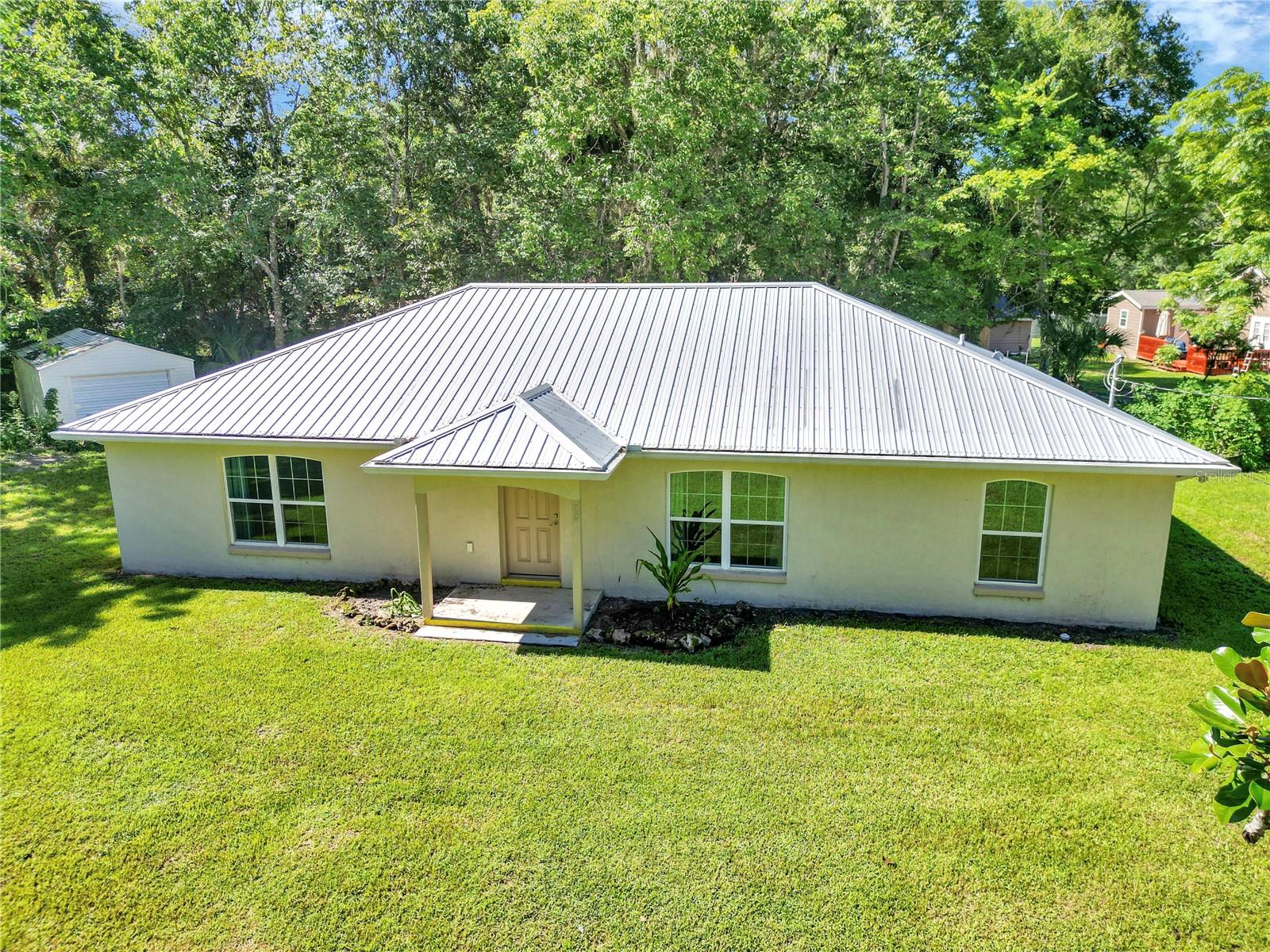 This beautiful 3 bedroom, 2 bath home—built in 2018—is situated on nearly an acre of land on the peaceful outskirts of Ocala, near Belleview. Surrounded by picturesque horse farms and just 5 minutes from the renowned Santos Bike Trail, this home offers the perfect mix of tranquility and outdoor recreation. Inside, you'll find vinyl flooring throughout, an oversized walk-in closet in the spacious master suite, and a bright, open layout. Step outside to a large screened-in back porch, perfect for relaxing or entertaining. A large shed is also included, providing plenty of extra storage space. This is the ideal rental for anyone looking to enjoy space, comfort, and nature—all in one!