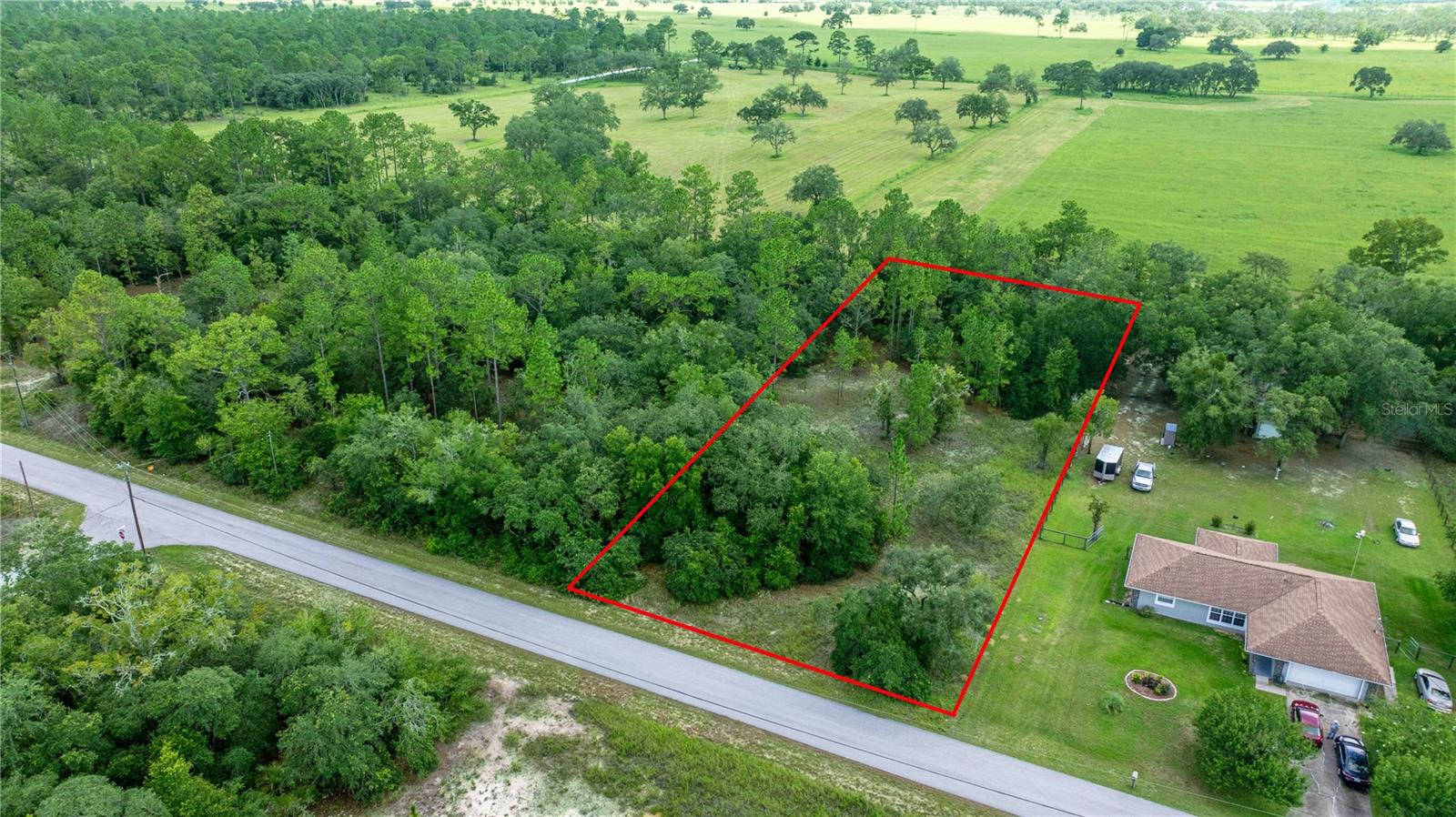 LOCATION LOCATION LOCATION.."The best investment on Earth is Earth”. The Ultimate Dream Home Checklist Starts with "THE PERFECT LOT" Imagine sitting on your own deck, enjoying a glorious florida sun set over 400+ acres of ranch land. Residential properties that overlook large ranches and farms are becoming increasingly rare. they can feature serenity, privacy and beauty. This property checks all the boxes " manageable size 1.03 acres " "North East/South West facing" "on a maintained paved road" "close to shopping, activity and recreation" "approx 20 miles to the Gulf of America or the Horse capital of the world Ocala fl." " short drive to Tampa, Orlando or Gainsville" Come to Dunnellon.."Central Floridas Sweet Spot".. .It's not complicated