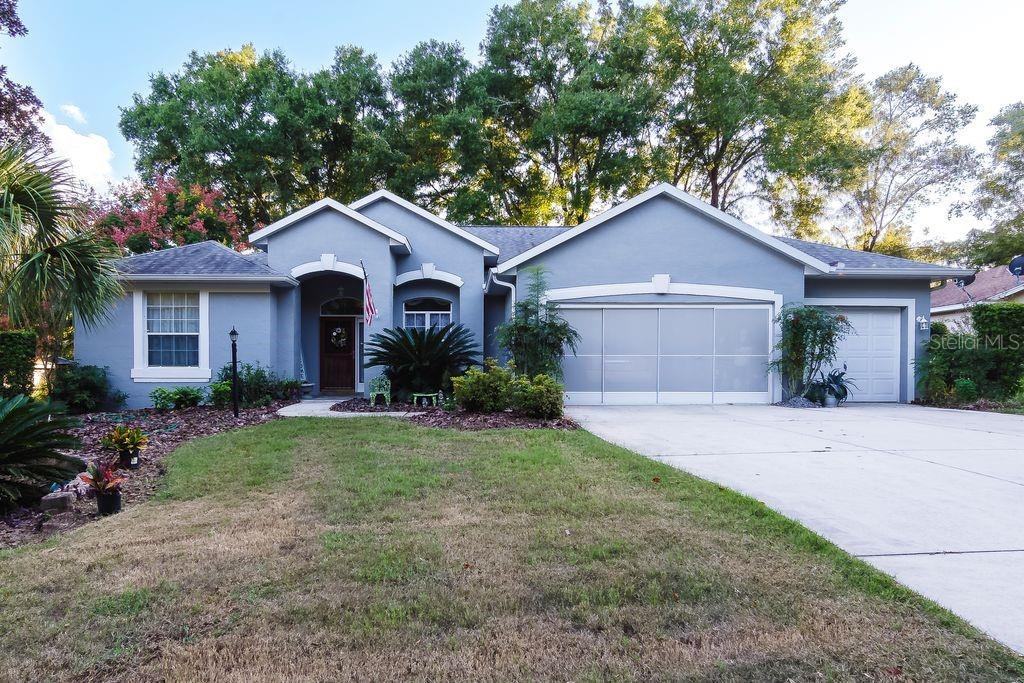 Welcome to Rainbow Springs Country Club, a premier community in Dunnellon/Ocala. This move-in ready home sits in a quiet, private setting. It offers comfort, convenience, and modern style. The house has 3 bedrooms and 2 bathrooms. There is a 3-car extended garage. The living space is 2,049 sq. ft. The lot is .26 acres and beautifully landscaped. Built in 1998, the home features a split bedroom floor plan. Guest rooms are spacious. The owner's suite has two walk-in closets, a shower, and a jet tub. The kitchen has solid wood cabinets, pull-out drawers, and granite countertops. The screened lanai is large and overlooks a tree-shaded backyard. It includes custom blinds, a sink, and cabinets for outdoor food prep. The home has a separate well for lawn irrigation. There is also a water softening system. The grounds have flowering shrubs and mature trees. The property is well maintained. Rainbow Springs residents enjoy many amenities. There is a private beach on the Rainbow River. You can use the kayak launch, grills, and pavilions. The community center has a restaurant, swimming pool, tennis and pickleball courts, fitness center, and frisbee golf. Schedule your private showing today!