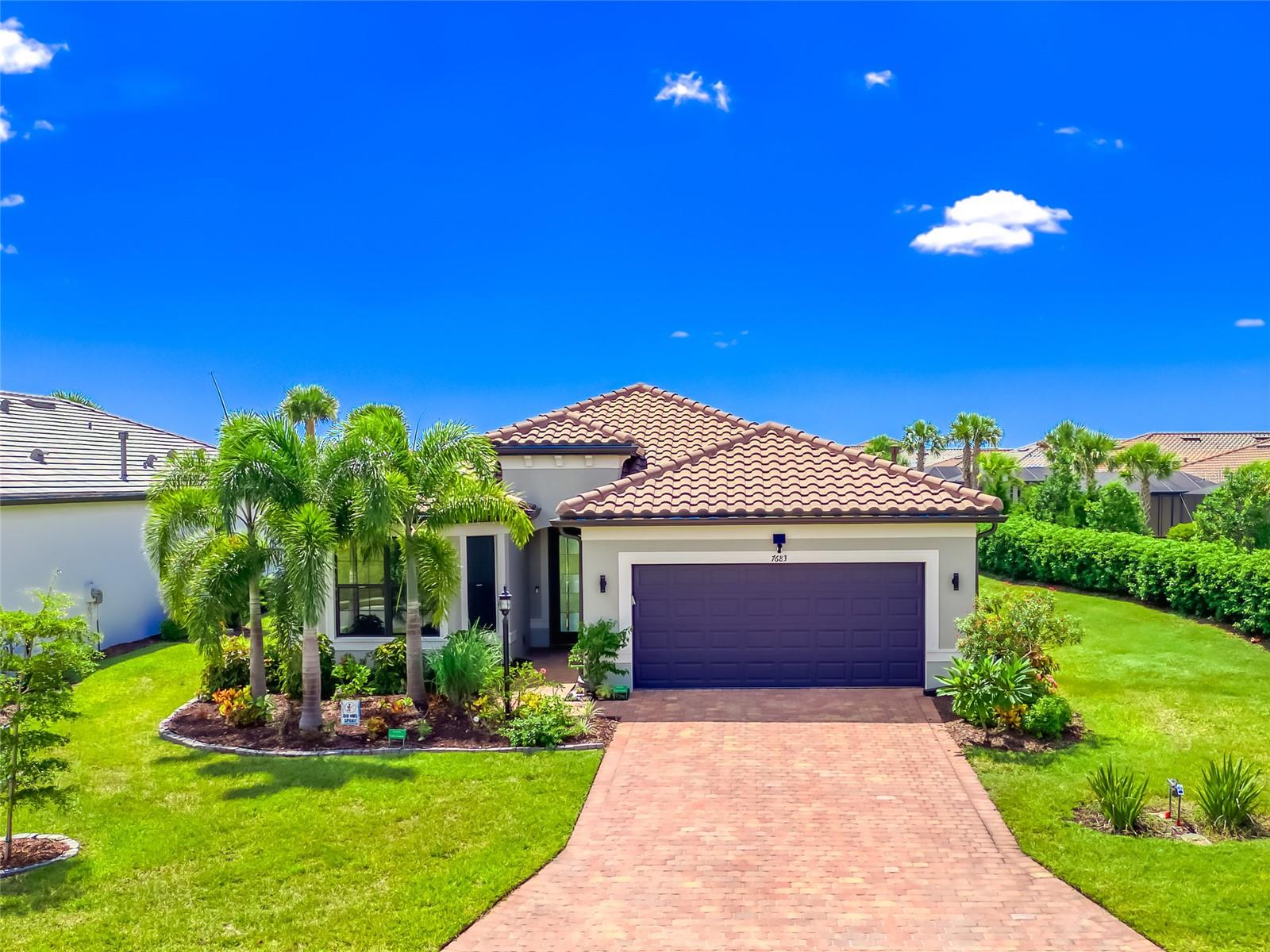 PRICE REDUCED! Gorgeous Home w/ a Fantastic Water View! Better than New - Built 2 Years Ago & Move-In Ready! Live like you are on Vacation...Every Day! A Dynamic Lifestyle awaits at Del Webb Lakewood Ranch a Premier, Gated, 55+ Resort Community! A Consummate Experience in Active, Luxury Living! Located on an Ideal Lot w/ unique Full Lake View, Privacy & Easy Access via a Rear Community Gate. WATER VIEWS & PERFECTION! Enjoy a Myriad of Custom Upgrades. Attention to every detail. Built in 2023, this extraordinary home offers a blend of Coastal Casual Style & Modern Sophistication. The stunning & sunlit Great Room w/ Tray Ceiling features Zero-Corner Pocketing Sliding Doors, opening to an expansive Lanai w/ tranquil Lake Views. An ideal spot for relaxing, dining or watching dramatic evening Sunsets over the Lake. Versatile Lanai offers Upgraded Ceiling Fans, Recessed Lights, TV hook-up & pre-plum for Outdoor Kitchen. Prepare meals & gather in a modern Chef’s Kitchen featuring a Large Island w/ Farm Sink, Breakfast Bar, Quartz Countertops & Walk-In Pantry. Upgraded Stainless Steel Appliances include LG Refrigerator, Microwave, Triple-Layer Dishwasher & Gas Stove that doubles as an Air Fryer. At the end of an active day, the Primary Suite is a relaxing Retreat!! Perfect spot for refreshing & rejuvenating! You are greeted by a panoramic View of the Lake through Large Windows. The Spa-Like En-Suite Bathroom features a Large, Walk-In Shower w/ Floor-to-Ceiling Tile, Double Sinks, Quartz Countertops, Linen Closet & private Water Closet. The colossal Custom Walk-In Closet offers abundant space for clothes & storage. The convenient Flex Room space can be used as a Den/Office or additional bedroom, to suit your needs. Separated for Privacy, the 2nd Bedroom features a charming Bay Window. Only steps to an adjacent 2nd Bathroom w/ Quartz Countertop, Custom Linen Closet, Tub/Shower combination, floor-to-ceiling tile & raised shower head for a “true rain head experience”. The private 3rd Bedroom is nearby, tucked away from main living areas. A large hallway closet is perfect for beach & pool supplies. Sizable Laundry Room offers abundant Cabinets, Counters, Farm Sink w/ custom spray nozzle & Spacious Storage Closet. Discover a convenient Drop Zone at Garage entrance. An Oversized 2-Car Garage features 4’ extension, Epoxy Floor, EV Charger & Overhead Shelving. You will appreciate the long list of Special Features & Details throughout the home. Enjoy Customized Flooring, w/ Luxury Vinyl Planks, Custom Closets w/ Wood Shelving, Marble Window Sills, Designer Lighting, Custom Paint & Window Treatments, 8’ Doors, 5” Baseboards & whole-house Water Filtration System. Enjoy Energy efficiency w/ Gas Hot Water Heater & UV Tinted Windows/Doors. Hurricane Shutters are available for windows & doors. The Gated & Maintenance-Free Del Webb community offers an extraordinary lifestyle, filled w/ a calendar of events, sports & social activities coordinated by a Lifestyle Director. The 28,000sf Clubhouse features a state-of-the-art Fitness Center, Billiards Room, Card Room, Game Room, Library & Party Spaces. Swim in the resort-style Pool or engage in Tennis, Pickle Ball, Bocce or Group Fitness Classes. Relax at the onsite Restaurant/Bar. Prime location just minutes from restaurants, golf courses & shopping. Lakewood Ranch is the #1 Selling Planned Community in the U.S. Close to I-75 & world-class beaches. Welcome to YOUR perfect home in Paradise!