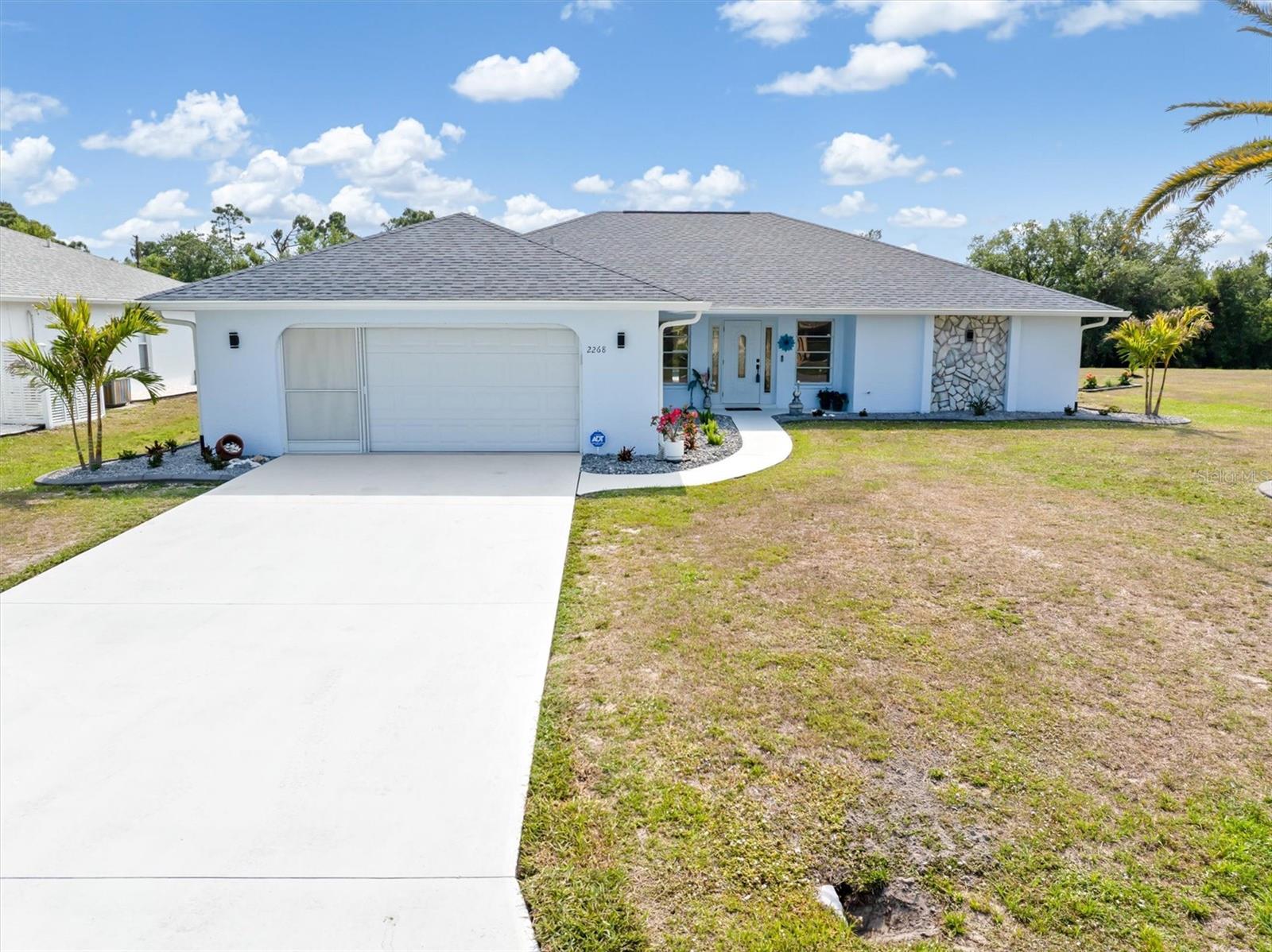 Step into the Florida lifestyle with a home that feels brand new and perfectly placed in one of Punta Gorda’s most desirable communities. Located in Deep Creek, a deed-restricted neighborhood known for its winding greenbelts and well-kept homes, this property combines thoughtful updates with a location that’s all about convenience and comfort. Remodeled in February 2025, the interior is bright, modern, and welcoming. Fresh paint inside and out, brand-new appliances, and a redesigned kitchen with dark cabinetry and striking granite countertops give the home a clean, updated feel. The adjoining dining nook offers a cozy space for morning coffee, with views of the pool and lush outdoor surroundings. The living area is both open and practical, enhanced by two added floor outlets to keep your space organized and clutter-free. Lighted vanity mirrors bring a contemporary touch to both bathrooms, each featuring updated vanities with granite surfaces. In the primary suite, a newly tiled walk-in shower creates a spa-like feel, while the second bathroom keeps with the theme, complete with a tiled shower stall and classic original flooring. The outdoor space is just as impressive. The pool has been resurfaced and the entire deck refinished, setting the stage for effortless relaxation. Two covered patio areas give you options for dining al fresco, entertaining guests, or simply escaping the sun. A new roof (2022), AC system (2022), and water heater (2018) add peace of mind, while new soffits, gutters, landscaping, and curbing finish off the home with a polished look front and back. For added security and storm protection, hurricane panels are included for all windows and doors. Golf Course located in the community as well! Life in Deep Creek means having access to more than just beautiful homes. This community offers peaceful surroundings with easy access to Peace River and Charlotte Harbor, where fishing, boating, and wildlife are always part of the plan. Nearby, you’ll find a mix of waterfront restaurants, local pubs, shopping centers, and boutique stores—plus all the events, art, and entertainment of downtown Punta Gorda just minutes away. Whether you're looking for a permanent residence or a winter escape, this home offers the best of Southwest Florida living. There is an additional Lot next door, available to purchase outside of this sale. some furniture may be available for purchase outside of the sale.