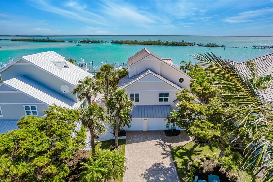 Don’t miss this rare opportunity to own a fully renovated, waterfront home on exclusive Boca Grande! Located within the walled and gated private community of Grande Quay, this elevated 3-bedroom, 2.5-bath custom home offers breathtaking views of Gasparilla Sound and highly desirable deep water boating access to the Gulf and Charlotte Harbor. Originally built in 1998, this single-owner home has been meticulously maintained over its lifetime. Over the last three years the property has undergone a comprehensive exterior and interior renovation. Upgrades include, but are not limited to, new James Hardie plank exterior siding and soffits, new interior and exterior paint, new roll-down storm shutters, new spray foam insulation, fully renovated kitchen and bathrooms, new flooring throughout, new high efficiency Trane air conditioners, new landscaping, and much more. On the ground level this home offers a spacious two-car garage with epoxy floor coating, abundant storage, a separate fishing tackle room, and large covered concrete patio with ample seating and BBQ grills. For avid boaters, the property includes an assigned 30-foot boat slip with a 10,000-lb. high speed boat lift on a newly constructed community dock, plus a secured boat trailer parking lot. Just outside the neighborhood's gates a dedicated landscaped bike and golf cart path leads directly to Boca Grande's charming and historic downtown district where a multitude of boutique shopping and dining options await. This elegant home literally checks all the boxes and you simply will not find a better waterfront value anywhere on Boca Grande.