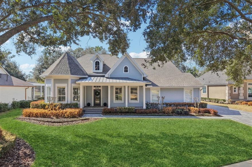 Keene's Pointe - 24 hour gated/attended golf community in Windermere, Florida.  This fully renovated home is situated on one of the most beautiful lots in the community.  Located on the 11th fairway of The Golden Bear Club with golf and pond views, as well as golf and pond views of the 12th green from the front porch.  Boasting an open floor plan with a dining room large enough to hold a table of 12, 3 bedrooms downstairs including the primary. The kitchen is functional with an island seating 4 with quartz waterfall edges, coffee bar, stainless KitchenAid appliances, Dacor panel refrigerator and pantry.  The great room has a wall of windows overlooking the patio and stone fireplace.  There is also a spacious office with desk and built-ins, and a second office/bar with built-ins that can be easily converted to a 5th bedroom.  The primary suite is spacious with a wall of windows overlooking the pond/golf course, bathroom with 2 vanities with lighted mirrors, free-standing tub, and shower with rain head and 6 body jets, and large walk-in closet. The second floor features the 4th bedroom, perfect as an in-law suite, media or game room with 2 walk-in closets and a bath with shower and tub.  Enjoy the view from the large covered patio with stone fireplace and summer kitchen overlooking the updated screened salt water pool and spa (new pump and heater in 2025), as well as the expansive and private back yard.  The side entry garage features two parking spaces and an additional golf cart parking area, as well as epoxy coated floor and built-in cabinets and overhead racks.  There is also steps to the attic over the garage with wood flooring for extra storage.  Everything in this home has been tastefully updated in 2025.  Wood-look tile and plantation shutters throughout, elegant lighting, tankless gas water heater (2025), pavered driveway and porch, new roof in 2021, AC's (2025/2018).  This home has everything that country club living has to offer.  Conveniently located to shopping, dining, expressways, tourist attractions and top-rated public and private schools.  Call for your private showing today.