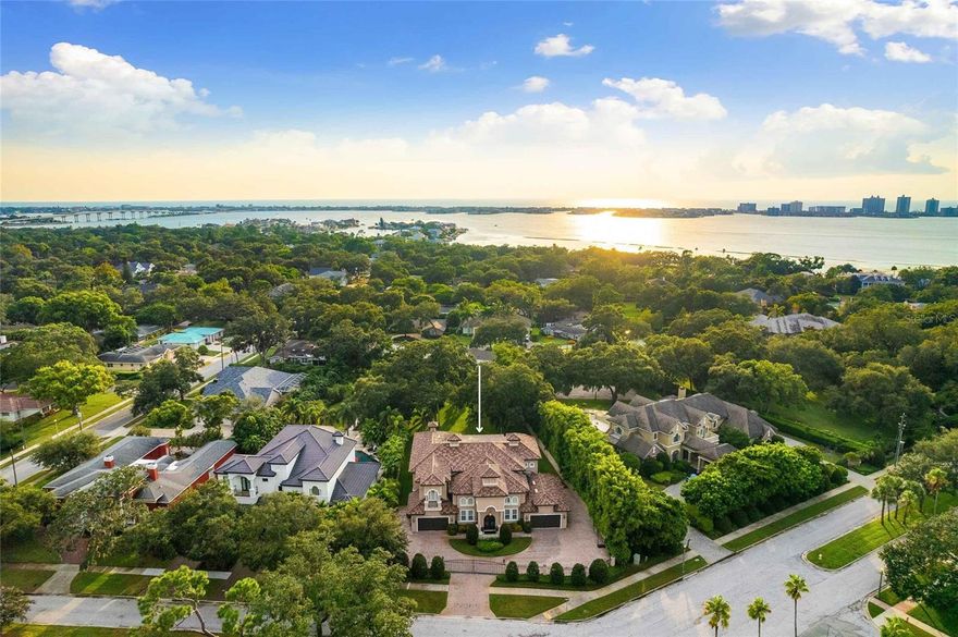 Experience unparalleled luxury in this exceptional estate, a true masterpiece of design and craftsmanship, offering over 5,500 square feet of opulent living space. Nestled behind a private gated entrance, the property welcomes you with an expansive paver circular driveway leading to a four-car garage, setting the tone for the grandeur within.
As you step through custom double doors, you're greeted by a grand foyer with soaring ceilings, exquisite, tumbled marble flooring, and a stunning wrought iron staircase, flanked by stately columns that guide you into the heart of this magnificent home. The tall ceilings amplify the sense of space, creating an elegant and sophisticated environment. The 8-foot doors enhance the grandeur of the home, offering a seamless transition between rooms and contributing to the overall feeling of luxury. This combination is perfect for those who appreciate architectural details that elevate the living experience, making the home feel both modern and timeless.
The two-story expansive family room is a showstopper, featuring a gas fireplace, floor-to-ceiling windows, elegant crown molding, and a bridged balcony connecting the East and West wings of the home and overlooking the beautifully manicured grounds & pool.
The gourmet kitchen, completely renovated in 2023, is a culinary artist's dream. It boasts a large center island, a butler's pantry, and top-of-the-line amenities perfect for both intimate gatherings and grand entertainment. The primary suite, conveniently located on the first floor, is a private sanctuary with a spa-inspired en-suite bathroom, featuring a luxurious walk-through shower and a jacuzzi tub. The recent installation of hardwood floors throughout the home adds a touch of warmth and sophistication.
Upstairs, you'll find four generously sized bedrooms and two versatile bonus rooms, ideal for a home office, gym, or media room or additional bedrooms. The second-story patio offers serene views of the lush landscape and the sparkling pool, with a spiral staircase descending to the pool patio. The 24,000-gallon heated saltwater pool is equipped with a state-of-the-art Hayward System powered by Omni Logic, allowing you to customize the lighting to create the perfect ambiance for any occasion. The outdoor kitchen is equally impressive, making alfresco dining a delight.
This estate is surrounded by a wrought iron fence in the front and block fencing in the rear, ensuring the utmost privacy. Additional upgrades include two tankless water heaters, a newly installed main gas line, and a water softener with a reverse osmosis system. Every detail has been thoughtfully curated to offer the ultimate in luxury living.