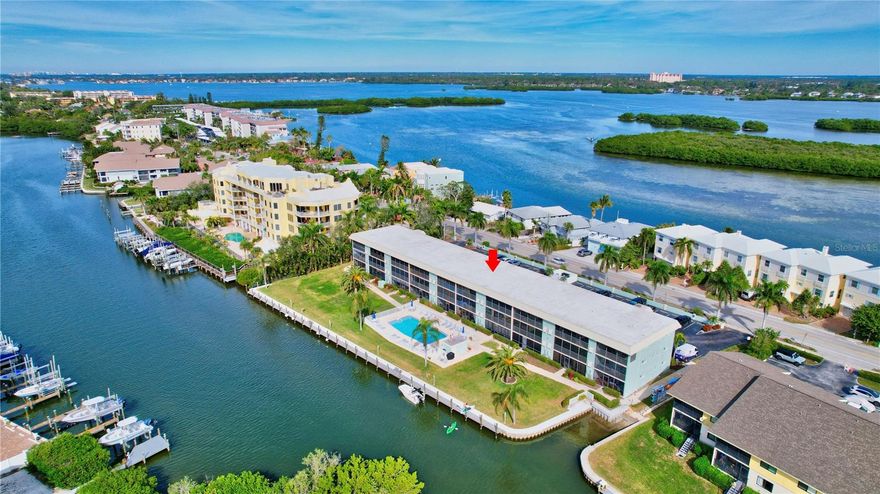 Discover the epitome of waterfront living in this coastal Siesta Key condo, boasting exceptional water views of Blind Pass & the Intercoastal Waters of the Gulf of Mexico.  This pet-friendly community offers kayak storage and launch facilities, along with a heated community pool right on the water’s edge.  For boating enthusiasts, boat docks are available for vessels under 26 feet to explore the vast network of waterways with no bridges to Bay.

This condo has been meticulously updated with custom finishes throughout, featuring luxury vinyl & tile flooring making weekend chores a breeze.  The open floor plan extends into a spacious 23-foot all-season lanai equipped with both glass sliders and screens, allowing for year-round waterfront enjoyment in a bright and ambient setting.  End each day as you relax with al fresco dining while enjoying the magnificent Sunsets.  Comfort meets convenience with two private bedrooms & two full bathrooms, ample closets, and storage space throughout.  The primary bedroom is an ensuite with glass sliders opening to the lanai, offering stunning waterfront views.  Bathrooms are modernized with Kohler floating vanities, under-vanity lighting and custom wall and flooring tile designs. Additional features include a breakfast bar and stainless appliances in the open kitchen design, a large stackable LG washer and dryer within the unit, as well as a proven track record of seasonal and annual rental history opportunities. Located with easy access to the free Siesta Key Trolley, residents can effortlessly reach the world-famous Siesta Key Beach or Siesta Key Village. Turtle Beach and several waterfront restaurants are also conveniently accessible, enhancing the allure of this exceptional property.  With a dedicated parking space and ample guest parking, this condo is a rare find in a sought-after location.  Experience the pinnacle of coastal luxury and make this Siesta Key gem your new home or investment opportunity.