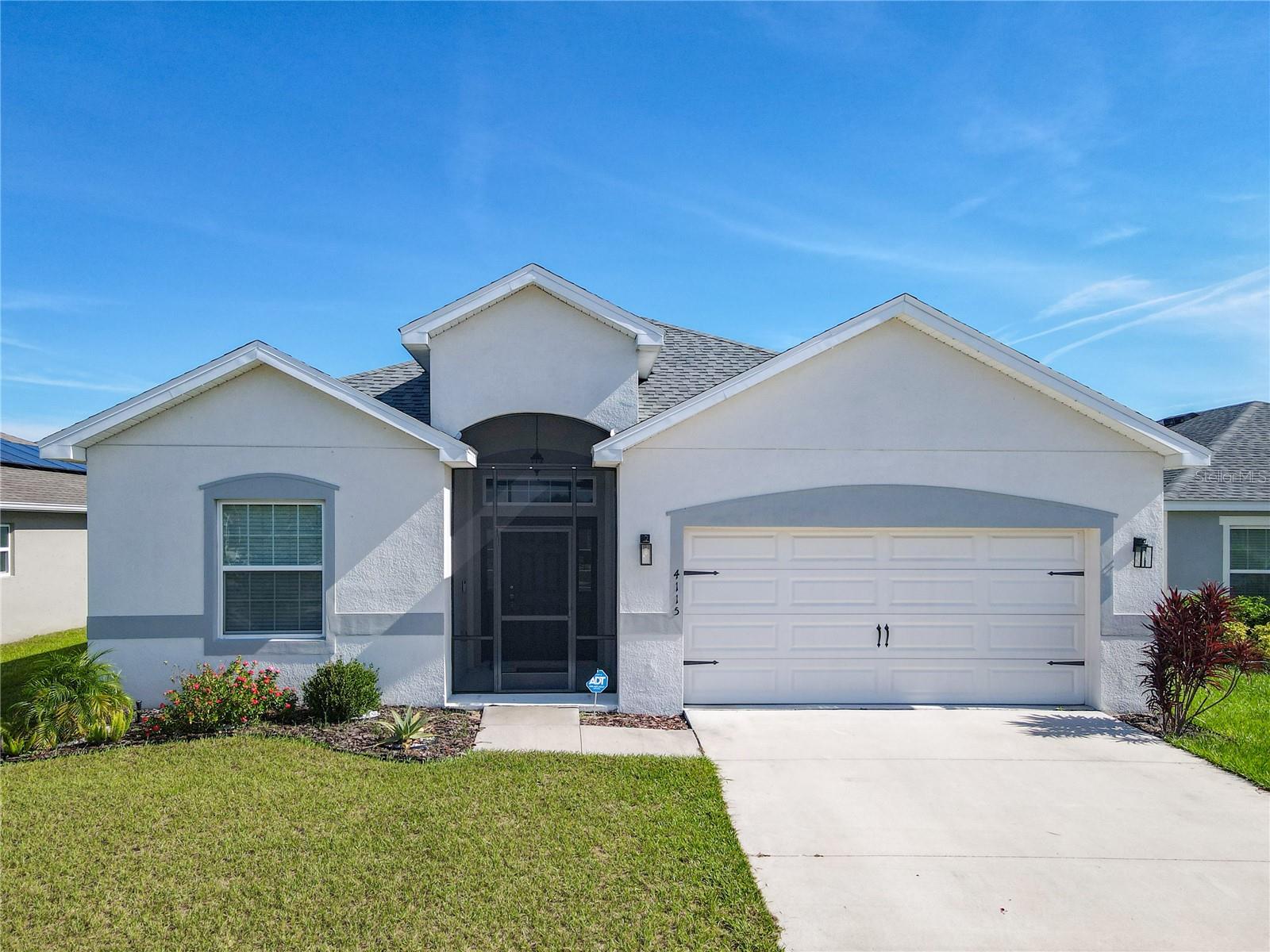 One or more photo(s) has been virtually staged. Come take a peak at this adorable 4-bedroom, 2-bathroom home is the perfect blend of modern design, smart upgrades, and everyday comfort. Built in 2022 and offering 2,032 sq. ft. of thoughtfully planned living space, it comes equipped with energy-saving BRAND NEW SOLAR PANELS and a fully paid-off PURE TOUCH WATER FILTRATION SYSTEM—both adding lasting value and convenience. Inside, an airy open floor plan seamlessly connects the living area, dining space, and a sleek kitchen featuring stainless steel appliances, plentiful cabinetry, and generous counters that inspire both casual meals and gourmet creations. The primary suite offers a private retreat with its own bath and walk-in closet, while three additional bedrooms adapt easily for guests, family, or a home office. A roomy laundry/mud area off the garage keeps things organized, and the screened front porch and lanai provide the perfect spots to enjoy Florida’s melow evenings—made even better by a private backyard with no rear neighbors. Just a short walk to community amenities like a pool, playground, dog park, and soccer field, and minutes from Legoland with easy access to Tampa and Orlando, this home offers small-town charm without sacrificing convenience. Ready to welcome its next owner, it’s a move-in ready opportunity you won’t want to miss.
