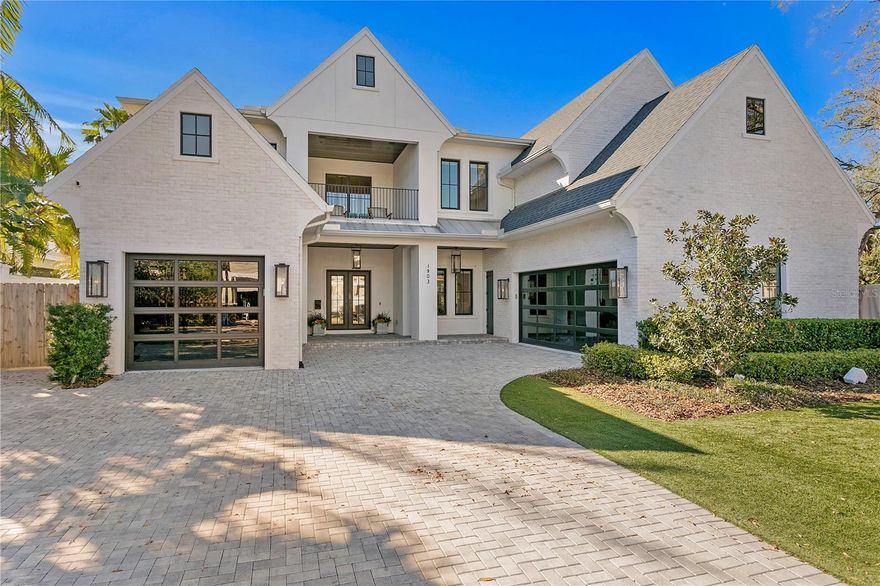 Welcome to 1903 S Cardenas, an extraordinary Brookshire custom-built home that epitomizes luxury and sophistication. Located in the highly coveted Golfview neighborhood of Tampa, FL, this stunning 5-bedroom, 7-bathroom, 3-car garage home offers 5,813 square feet of meticulously crafted living space. Built in 2020, this property combines modern elegance with timeless Tudor-style charm, offering an unparalleled living experience. From the moment you enter the dramatic 23' foyer, you'll be captivated by the exceptional attention to detail and craftsmanship throughout. Designed with the finest materials, this home boasts wide plank French oak flooring, marble countertops, and designer plumbing and lighting fixtures throughout. The versatile open floor plan effortlessly blends functionality with luxury, making it perfect for both everyday living and elegant entertaining. The heart of the home is the stunning kitchen, which showcases high-end cabinetry, exquisite plaster finishes, and Thermador appliances. Whether you're preparing a casual meal or hosting a gourmet dinner, this space is designed to impress with its exceptional style and state-of-the-art functionality. The owner’s suite offers a retreat like no other, with over 430 square feet of closet space and an expansive master bath, ensuring your comfort and privacy. The master suite’s views of the lush, private backyard and pool area provide the perfect setting for relaxation. Step outside to your personal paradise—an incredibly private backyard with a saltwater pool and spa, covered lanai, and an alfresco outdoor kitchen complete with a grill, sink, and beverage fridge. The lush artificial turf, custom landscaping, and hardscaping wrap around the entire property, creating a serene environment perfect for entertaining or unwinding. This home is equipped with cutting-edge technology, including full home automation system and Lutron power shades throughout, ensuring convenience and comfort at your fingertips. For wine lovers, the 400+ bottle climate controlled wine cellar offers a luxurious space to store your collection. Stay fit with your own home gym, featuring cork flooring, or rest easy knowing you have a whole-home 38 kW generator ensuring uninterrupted power. Nestled on a private, dead-end street within the prestigious Golfview neighborhood, this spectacular estate offers an unrivaled combination of timeless design, modern amenities, and extraordinary craftsmanship. Don't miss this opportunity....schedule your private showing today!