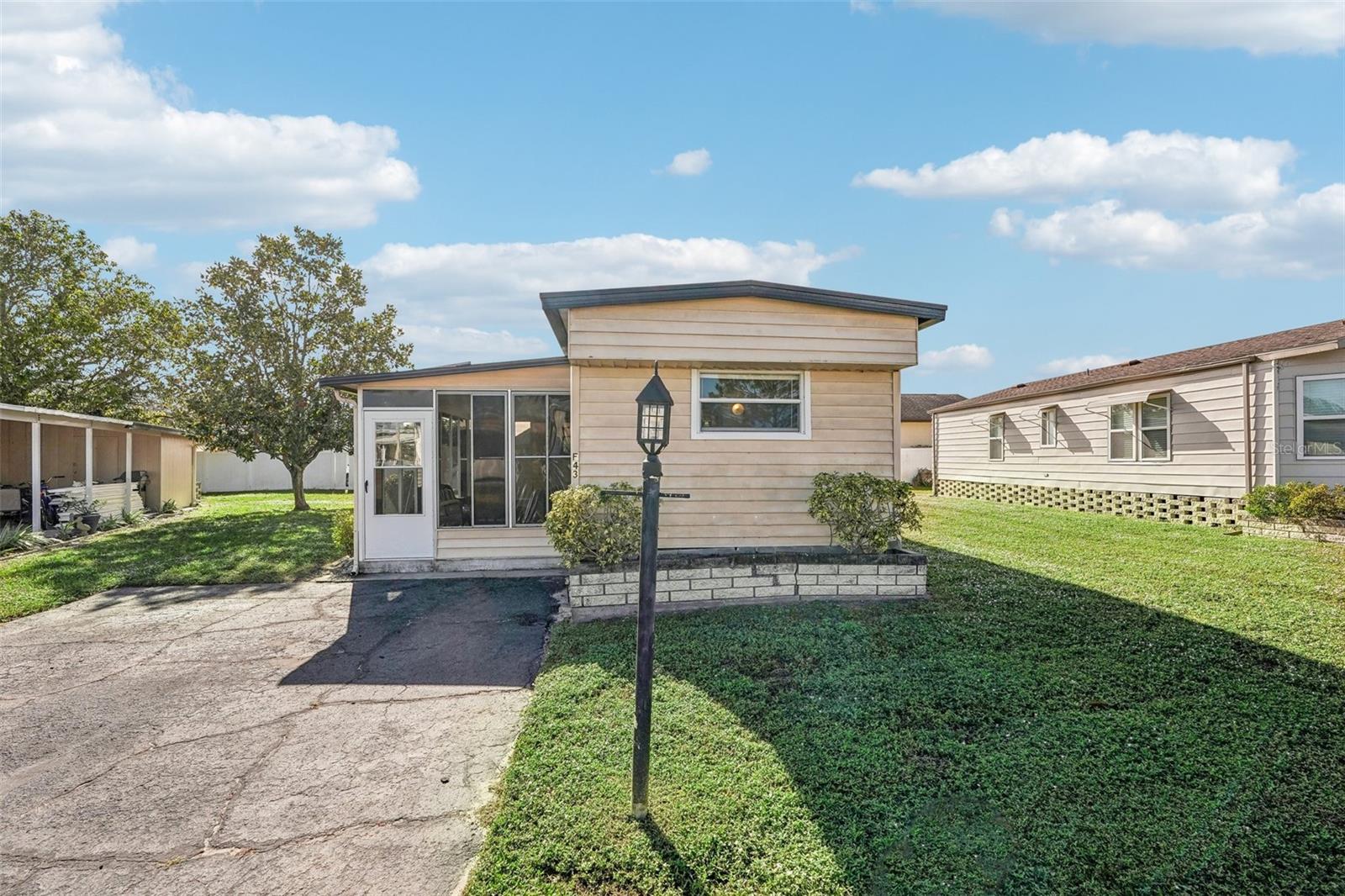 Welcome to Westwinds Village, a charming 55+ age-qualified cooperative community in Bradenton, Florida. This is NOT LOT RENT, and the sales price includes a share in the community! This community has a great location on US-70, with quick access to the Gulf beaches, or to I-75. There are two entrances to the community, and there is a traffic light available as well for less stress! This home is located near the back entrance to the community, and is also close to the office and clubhouse! It's a single wide, but don't let that fool you. This is a TRUE 3 bedroom / 2 bathroom home! The carport isn't missing from the storm; this home never had one! You could add one if you wish, or leave it carport-free! But no carport to begin with means no damage from a missing carport from the recent hurricanes. In fact, this home has NO DAMAGE from the storms! When you approach the home, you'll first come upon the screened in lanai. It has vinyl windows, which you could either remove to have it just screened, or replace with glass windows. Inside, you'll notice the floor plan is split, with one bedroom (with an ensuite bathroom) in the front of the home, and the other two bedrooms in the back. These are the ORIGINAL OWNERS, and the home needs updating (there are a few soft spots in the floors, for example). However, it can be moved into immediately, with updates happening when convenient for you! The 2nd bedroom is small, and what some people have done in similar layouts is converted this room into a storage / laundry room. There is an old wall unit AC, but that can be removed when renovating, as the home is ducted with Central AC that was just serviced in December 2024. This home is sold FULLY FURNISHED and is ready for its new owners! Westwinds is one of the most amenity-rich communities in the area. Some of the amenities include: pool, clubhouse, shuffleboard, billiards, library, and lawn bowling! This home is ready for immediate closing; schedule your showing today!