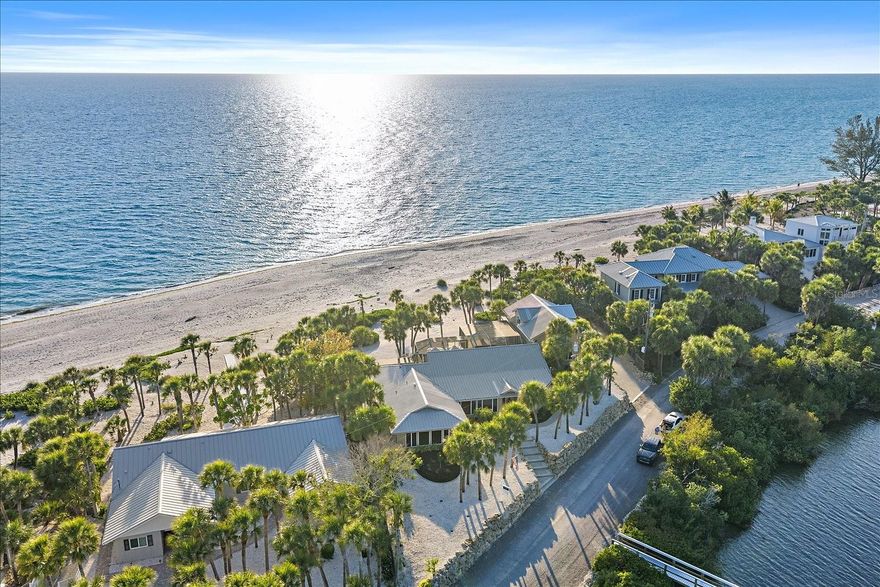 Breathtaking Gulf-to-Bay living awaits on the coveted, private north end of Manasota Key. This rare beachfront estate spans from the turquoise waters of the Gulf to the calm shores of Lemon Bay, offering approximately 155 feet of direct Gulf frontage, 155 feet of bay frontage, and nearly 299 feet of depth, creating an extraordinary setting that is increasingly difficult to find. With ownership extending to the mean high water line, the property captures sweeping water views, spectacular sunsets over the Gulf, and tranquil sunrises across Lemon Bay.

Enjoyed by this family for almost 30 years, the residence offers 5 bedrooms, 4 bathrooms, and 4,033 square feet, including a 3 bedroom, 3 bath main home (3,073 sq ft) and a private 2 bedroom guest apartment above the garage (960 sq ft) with its own living room, providing ideal flexibility for family and guests. Designed to embrace the outdoors, multiple windowed doors throughout the home open to the pool, beach, bay, and surrounding property, allowing natural light to fill the interior while creating seamless indoor-outdoor living.

The living room features cathedral ceilings, cypress accents, built-ins, surround sound, and sliding glass doors leading to the screened pool area. A bayfront dining room is framed by Andersen windows, while the kitchen enjoys water views from the sink and offers Corian countertops, wood cabinetry, Thermador cooktop, GE double ovens, GE Monogram refrigerator, and two pantries with breakfast seating.

Outdoor living is at the heart of the home with a heated pool, expansive 18x48 open lanai, covered grilling area, and spacious entertaining areas just steps from the sand. On the bay side, a private dock re-decked in 2025 (approx. 89 ft long) with water, electric, and fish cleaning station allows convenient boating along Lemon Bay and access through Stump Pass to the Gulf.

Additional highlights include a 2021 metal roof, impact windows, impact doors, three AC systems (2018, 2022, 2023), septic system replaced in 2016, PVC plumbing, pool cage 2025, and a baseline elevation of approximately 12.9 feet. The fully fenced property enhances privacy while preserving the stunning coastal views.

From the dock, curate the perfect day on the water by heading south through Lemon Bay and tying up along the way at local waterfront favorites including Beachcomber Trading Post for breakfast, The Lighthouse Grill or Magnolias on the Bay for lunch or sunset dining, and The Waverly Restaurant & Bar for cocktails before continuing through Stump Pass into the open Gulf for an unforgettable evening on the water.

Join the optional Manasota Key Club for additional amenities such as: pickleball, bocce ball, fine dining, tennis courts, community pool and vacation cottages that can be rented, along with great walking paths. See attachments for details. 

Check out the Hermitage Artist's Retreat as well, an incubator for diverse and original works across all artistic mediums, who host accomplished and diverse artists on Manasota's very own Gulf-front campus!

Located along one of the most desirable stretches of Manasota Key, this exceptional property offers the rare combination of dual waterfront, privacy, boating access, and breathtaking natural beauty—where mornings begin with dolphins offshore and evenings end with unforgettable Gulf sunsets.
