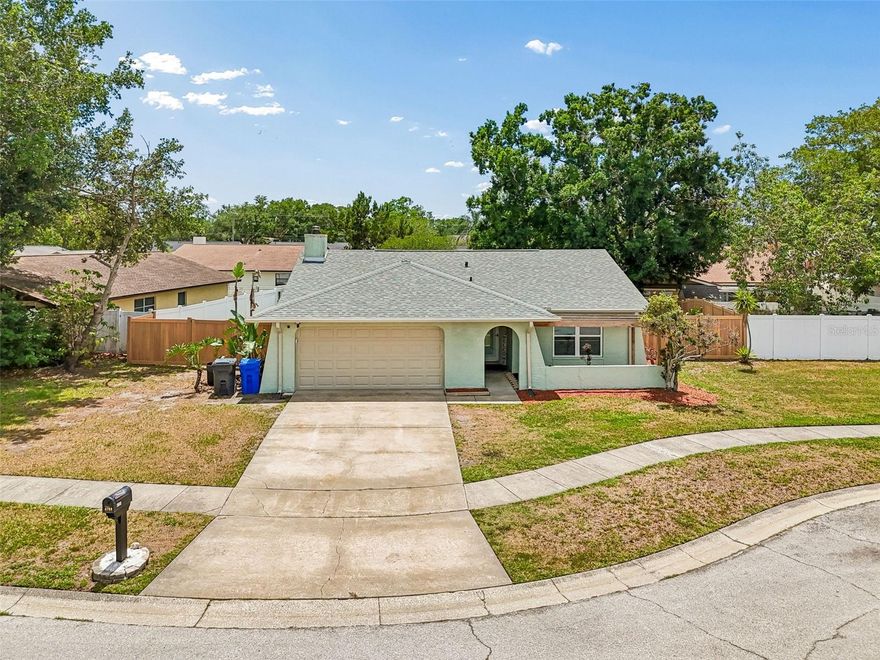 Welcome to 4706 Wandering Way, Tampa, FL 33624  a beautifully updated home located in the highly desirable Carrollwood area, offering the perfect blend of comfort, style, and convenience. Positioned on a quiet cul-de-sac with virtually no through traffic, this 2 bedroom, 2 bathroom home delivers exceptional curb appeal and a peaceful setting surrounded by well-maintained homes. From the moment you arrive, you’ll notice the inviting front entry with a charming trellis and thoughtfully designed landscaping. Inside, the home features a functional and open layout with tile flooring throughout the main living areas, creating a clean, modern feel. The fully updated interior includes fresh paint, newer windows, and upgraded finishes throughout. The spacious family room centers around a cozy wood-burning fireplace, adding warmth and character to the space. The kitchen has been tastefully renovated with granite countertops, newer cabinetry, stainless steel appliances, and a convenient bar seating area that seamlessly connects to the main living space ideal for entertaining or everyday living. Tray ceilings enhance the openness and elevate the overall design. Both bedrooms are generously sized, with updated flooring and modern lighting. The primary suite offers a private en-suite bathroom with a beautifully updated walk-in shower, while the guest bathroom has been fully remodeled with a tub/shower combination. Step outside to enjoy a covered and enclosed patio, perfect for year-round relaxation, overlooking a fully fenced backyard. The yard offers ample space, a wide lot configuration, a large gate for easy access, and a storage shed. The unique wood-look privacy fence adds both style and durability. Additional highlights include a newer roof, updated systems, and a move-in ready condition that makes this home ideal for homeowners or investors alike. Located just minutes from shopping, dining, parks, and major roadways, this Carrollwood gem offers convenience without sacrificing tranquility.
(ROOF-2026)(A/C-2021)(W/H-2021)(FENCE-2020)(CUSTOM ALUMINUM HURRICANE PANELS-2020)