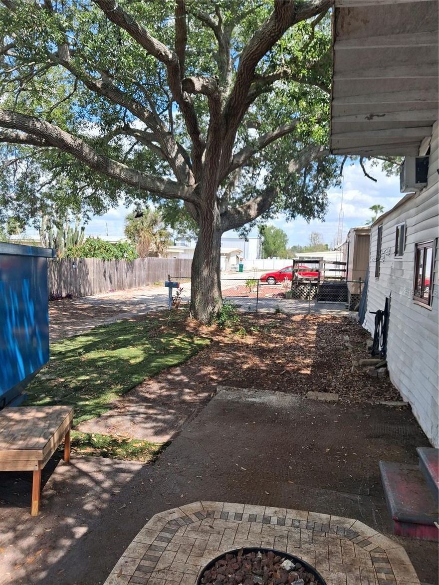 Gem at Sunset Point and US 19.  LAND INCLUDED….NO HOA FEES.  HAS MOBILE HOME ON IT WITH SHADY OAK TREE ….HOME HAS SEPTIC AND IS WITHIN WALKING DISTANCE OF ALDI (3 minute walk with no crossing the street) 1 minute access to US 19 …HAS A GREAT FULLY FENCED BACKYARD READY FOR A BBQ GRILL….GOOD SCHOOLS….