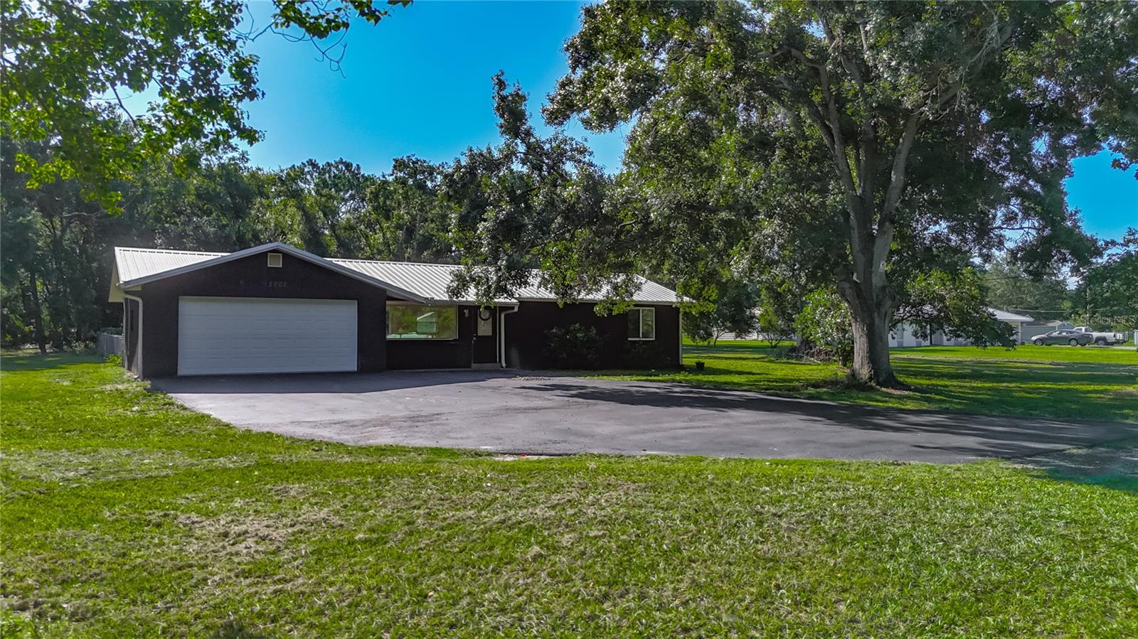 One or more photo(s) has been virtually staged. Not one, two, three, or four, but FIVE acres await you at 12808 Arcadia Lane. Welcome to this unique opportunity to own a large property while also living close to everything. Situated less than a mile from US 301 and just north of Big Bend Rd, you have quick, easy access to I-75 and your daily necessities. Hear that? It sounds like freedom - NO HOA. NO CDD. Flood zone X. Zoned Agricultural AS-0.4 with Future Land Use R-4. You can bring your animals, RV, toys, and more. There’s plenty of room for it all. Freshly painted inside, the block and stucco home has a metal roof (2015), large living room, two bedrooms, one bathroom, a two-car garage, in-ground pool, and a massive driveway for anything you want to park. A renovation loan may be the perfect option to turn the blank slate kitchen into your ideal culinary layout. Schedule your showing to view the home, reimagine it to suit your needs and walk this large parcel to see how you can take advantage of over 218,000 square feet of high and dry land in the South Shore area. Cash or renovation loans are suitable for this property.