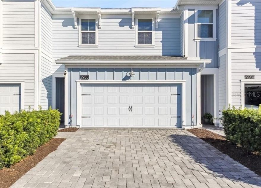 This immaculate home can now be yours! Welcome to this beautiful 3-bedroom, 2.5-bathroom, 2-car garage townhome, perfectly situated in the highly sought-after neighborhood of Reflections at Storey Lake in Kissimmee with RESORT-STYLE AMENITIES just minutes from world-famous attractions. Built in 2019 and offering over 1800 SQUARE FEET of living space, this home feels nearly brand new with an OPEN floor plan with HIGH ceilings and continuous TILE flooring throughout the first floor. Thoughtful touches like recessed lighting and abundant natural light create a warm, inviting atmosphere. The Kitchen is perfect for the chef in the family as it features an ISLAND with cabinets & pendant lighting, modern Gray 42-INCH CABINETRY with Crown Molding, quartz countertops, stainless steel appliances, subway style backsplash, a breakfast bar, and a closet pantry. The kitchen overlooks the spacious living and dining room. A half bathroom is conveniently located downstairs as well. Upstairs you will find all bedrooms with a split plan for privacy. The PRIMARY SUITE offers a tray ceiling, expansive WALK-IN CLOSET and an EN SUITE BATHROOM. The en suite bathroom has a DUAL sink vanity, GARDEN TUB, step-in shower, and private water closet. Also upstairs are two additional bedrooms, full bathroom and a conveniently located laundry room. Outside your new home has an extended back patio with pavers ready for you to relax or entertain. Reflections includes a RESORT style pool, clubhouse, fully equipped gym, playground, walkout dock, and green-space parks, making every day feel like a vacation. For an additional fee you can also have access to the Storey Lake Master Resort Amenities including a tropical pool with lazy river, waterslides, splash pad, fitness center, clubhouse with café/bar, mini-golf, kayak rentals, sports courts, and playgrounds. Residents love being just minutes from Walt Disney World, Universal Studios, SeaWorld, and the Orlando International Airport.  Easy access to top shopping and dining destinations, major roadways like SR 417, Osceola Parkway, and I-4 for EASY COMMUTING. This beautiful townhouse offers everything you are looking for!