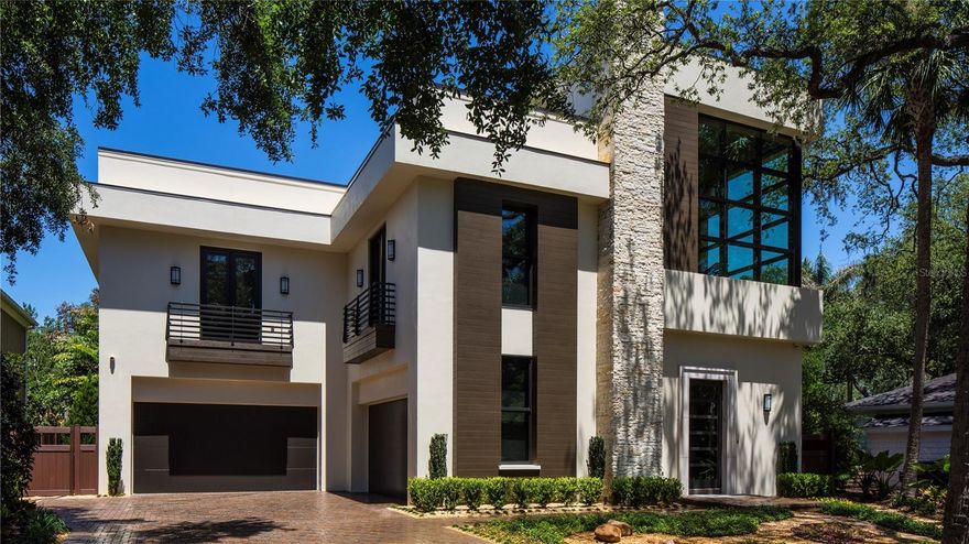 This extraordinary, award-winning contemporary home is an exquisite blend of thoughtful design and function. Custom built by Windstar in 2017, the home sits perfectly under a canopy of oaks on one of the most stunning streets in Bayshore Beautiful. Architecturally composed with fine living and entertaining in mind, your guests will be immediately impressed by the 42” custom pivoting steel door, 3-story stacked stone foyer with pendant lighting and floating walnut staircase. This 3- story spacious home features superior concrete block construction, elevator to all levels, hurricane rated window & doors, tankless gas water heater, CATV 5 wiring, water filtration system, outdoor landscape lighting, Savant whole house sound system, security cameras inside and out and so much more. Are you a car enthusiast...you’ll be thrilled with the garage space for 5 cars that is climate controlled, with slimline Mitsubishi split a/c systems, and can also double as an entertainment area with doubled sided garage doors opening to the back yard. The culinary arts inspired kitchen provides inspiration and includes all Thermador appliances, Busby custom cabinetry and tremendous counter space featuring leathered quartzite countertops. The additional cocktail bar equipped with dual 84” Thermador wine towers and a Scottsman will thrill even the most serious of mixologists. The first floor living space brings the outdoors in with EuroWall glass doors that open to the manicured backyard space with an emphasis on privacy. Whitewashed, wide plank oak hardwood flooring is featured throughout and adds to the home’s elegance. Once upstairs you’ll find a custom designed one-of-a kind cinema with Cinema Tech custom seating for 8 with a 120” movie screen, stage for entertainment, custom mood lighting, and concession stand with 2 refrigerated drawers! Continuing on the second floor is the luxury hotel inspired master suite and additional 2 bedrooms and baths. What may be your favorite part of this residence is the 3rd floor sky deck that was built for entertaining from sunrise to sunset. The massive rooftop provides the ideal space to unwind with covered bar, outdoor kitchen, complete sound system and large screen TV. If ease of living in luxury surroundings is something you’ve dreamed of...look no further. For the buyer’s convenience the home is coming fully furnished! Your oasis awaits!