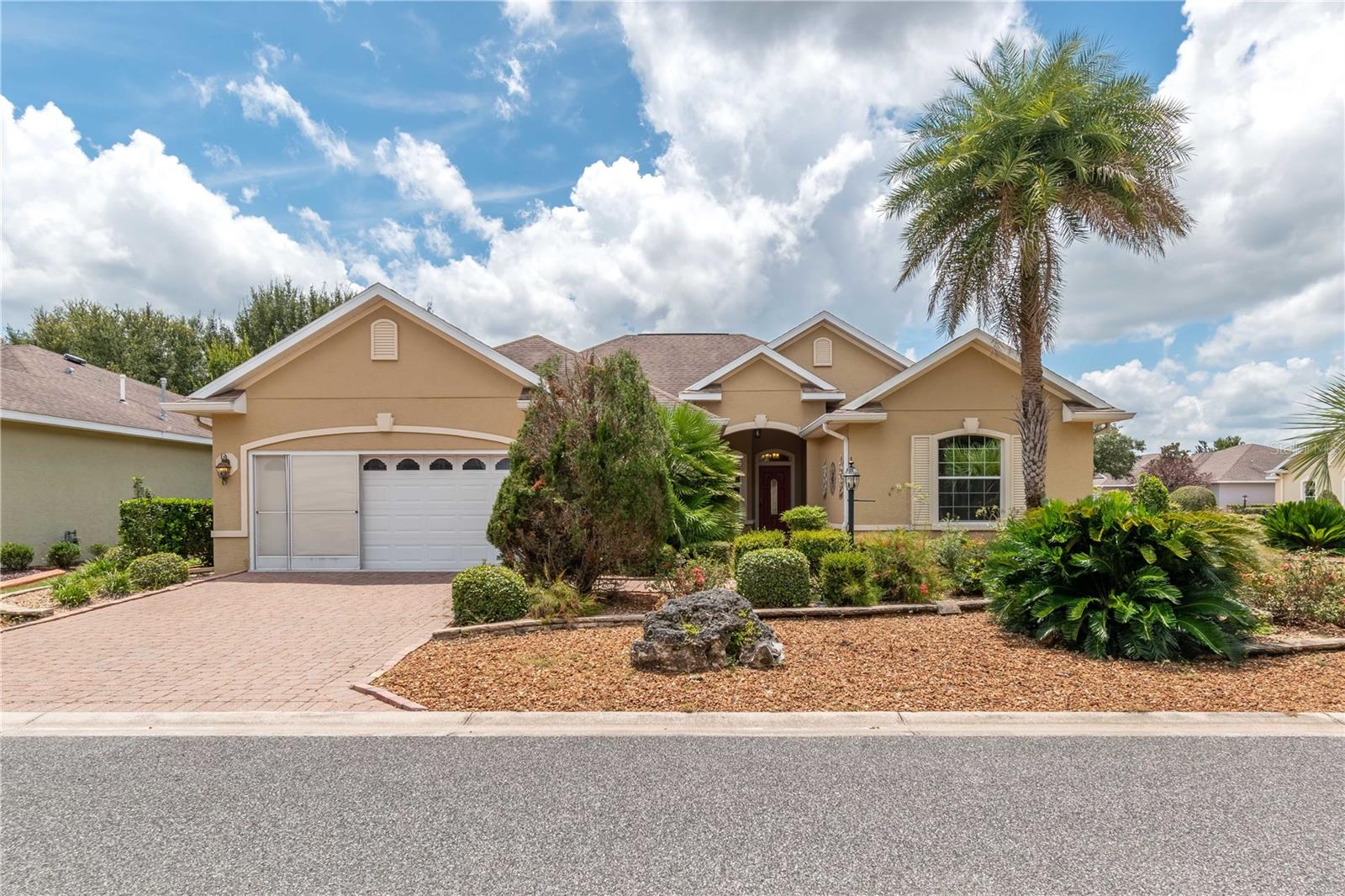 This beautiful home is the Huntley 11 EXP Model with 2635 SQ FT The home features 2 /2/2 plus 17X14 bonus room. The home has a nice flow to it for easy entertaining. Has an Island Kitchen with Lots of Cabinets and Granite Counter tops and solar tube for extra lighting. Stainless Steel Appliances including a French Door refrigerator and Gas Counter Top range. Eat in Kitchen Area leads to the four season Lanai which is glass enclosed, tile floors and vented for heat and air. Great for year round enjoyment overlooking the lovely landscaping and fountain. There is a separate formal dining room. Large Master Suite with tray ceilings, crown molding, garden tub with shower and oversized walk in closet. Inside Laundry Toom with upgraded Washer and Dryer and a Laundry Tub. Garage has a 1.5 ton Mitsubishi mini-split air co. this home requires minimal exterior maintenance with its low-maintenance rock landscaping. Located in Ocala's premier 55+ gated community, Candler Hills at On Top of The World, you'll enjoy a wealth of amenities, including multiple golf courses, shopping, fitness centers, restaurants, Added insulation in the attic and Garage Refrigerator included. Driveway as well as front walkway is done with pavers and golf cart access to two shopping centers just outside the front gates. Bonus: The CDD is fully paid! Call today to schedule a showing.