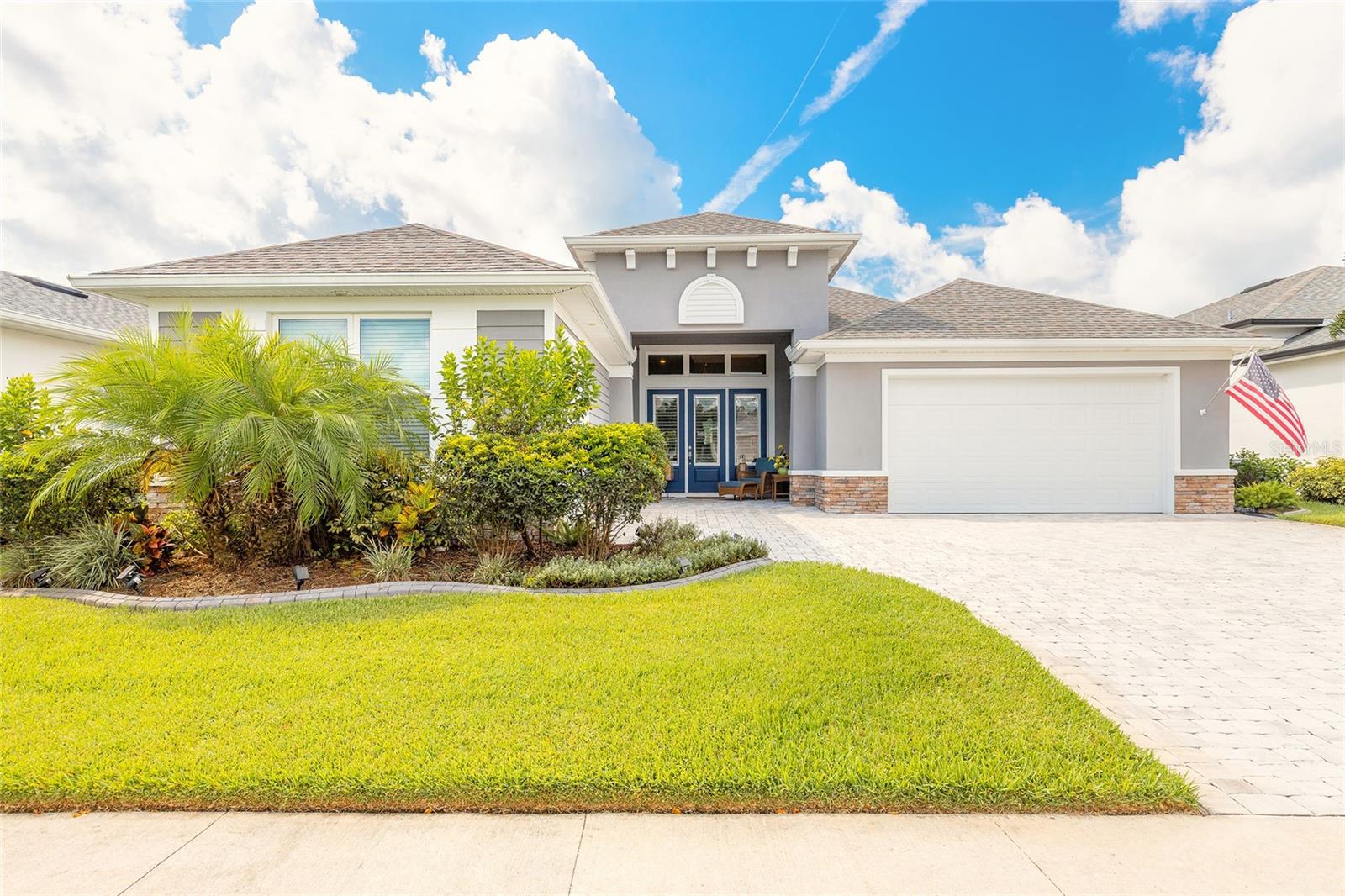 Experience spectacular lake views in this stunning 4-bedroom, 3-bath Johnson-built pool home, beautifully situated on one of the largest lakes in Venetian Bay. The welcoming coastal ambiance is enhanced by vinyl flooring throughout, soaring 12-foot ceilings, elegant crown molding, and charming plantation shutters. Natural light pours through a sun tunnel, illuminating the kitchen's stylish two-tone cabinetry in fresh white and rich espresso. The home's open-concept layout seamlessly connects the living, dining, and kitchen areas, all offering breathtaking lake vistas. The spacious kitchen features a generous center island, ample cabinetry, and premium stainless steel appliances, perfect for both entertaining and everyday functionality. Privacy is thoughtfully designed, with two bedrooms sharing a full bath in one wing, a separate bedroom suite with a soaking tub bath in another, and a serene primary suite located at the home's rear, complete with picturesque lake views and direct lanai access through glass sliders. Relax or entertain outdoors in the expansive screened lanai overlooking the solar-heated pool adorned by a vibrant, hand-painted mural capturing Florida’s essence. The oversized two-car garage offers 4ft of extra depth and a premium floor coating complemented by an additional "toy garage" ideal for a golf cart, workshop, or extra storage. Meticulous landscaping bordered with decorative concrete curbing enhances the sophisticated curb appeal of this exceptional property. Truly a must-see! All information is intended to be accurate, however not guaranteed.
