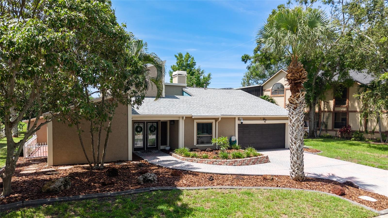 Welcome to waterfront living at its finest. This home is located in the highly desirable Seminole Lake Golf and Country Club community! This move-in condition well-kept home features 4-bedrooms, 3-bathrooms with 0.44-acre lake-front lot with an oversized two-car garage. It also features a large, screened pool for family gatherings and entertaining friends. The pool also has a newer natural gas heater which was installed in 2023. A Newer ac unit which was installed in 2021, with a 10-year labor and parts warranty. The roof was replaced in May of 2025. The home offers indoor and outdoor living with an open functional floor plan with an atrium. Upon entering through the grand double doors, you are astonished by the breathtaking views. The perfect place for sunsets. The home displays elegance and comfort for all occasions. The kitchen has custom cabinetry, granite counters, stainless appliances, gas cook-top and a breakfast bar. The home has gas which assists with lower utility bills. The home also features a home security system which is wired 14 PoE IP cameras with remote viewing and AI motion alerts. This travertine home also has a WHOLE HOUSE natural gas generator, accordion hurricane shutters and Jacuzzi tub, wet/dry sauna, separate shower, updated vanities and has never been affected by hurricanes or flood. The lawn is manicured with mature landscape and trees. Your address is located near the Seminole Lake Golf Course and close to shopping, dining, great schools and a short trip to the beautiful Gulf beaches. Schedule your showing today and live the Florida lifestyle. Don’t miss out on making this dream home your own.