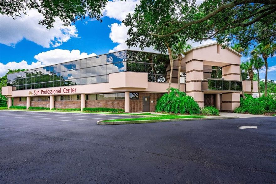 Available for sale for the first time ever - the SUN PROFESSIONAL CENTER! Located directly on Zephyrhills main trade corridor, this 2 story SOLID built Professional Office Center was constructed to the highest standards consisting of concrete block, real brick, steel beam and steel girder materials. The Center offers approximately 24,159 sq ft of rentable space with approximately 6,055 sq ft of common area for a approximate total interior under roof of 30,214 sq ft.  The west entrance features a welcoming open air atrium with an active water fountain feature and ambient natural lighting from the skylight above.  Beautiful glass paneling window wraps around the second story of the building.  The center's common area and suites have been renovated and updated to today's colors and standards, the complete exterior has been recently painted, and the parking lot has been freshly restriped and sealed. Brand new exterior parking lot LED lighting has also been installed. The land is approximately 4.44 acres and features a 'second phase' area with preliminary engineering plans for an additional free standing building consisting of approximately 12,500 sf up to 14,000 sf.  The center primarily consists of medical practice and medical based tenants, however the property is zoned C2 for other business type uses as well. More than ample parking areas which are a commodity in today's professional office centers. Access from Gall Blvd (US 301) and there is a north/south frontage road that also provides ease of access as well as being directly on the Pasco County Public Transit line.  Monument signage at the entrance provides an easy to read directory of the tenants in the center. Commercial corridor neighbors include Florida Medical Clinics main Zephyrhills campus, Advent Hospital Zephyrhills, and both Publix and Super Walmart centers and multiple main stream restaurants. An ideal investment for commercial rental income with future expansion, or for a owner/user that also would be able to generate additional income on site.  Contact agent for more details. Offered at $4,200,000.00. which includes the center, existing leases, and land with additional future phase.