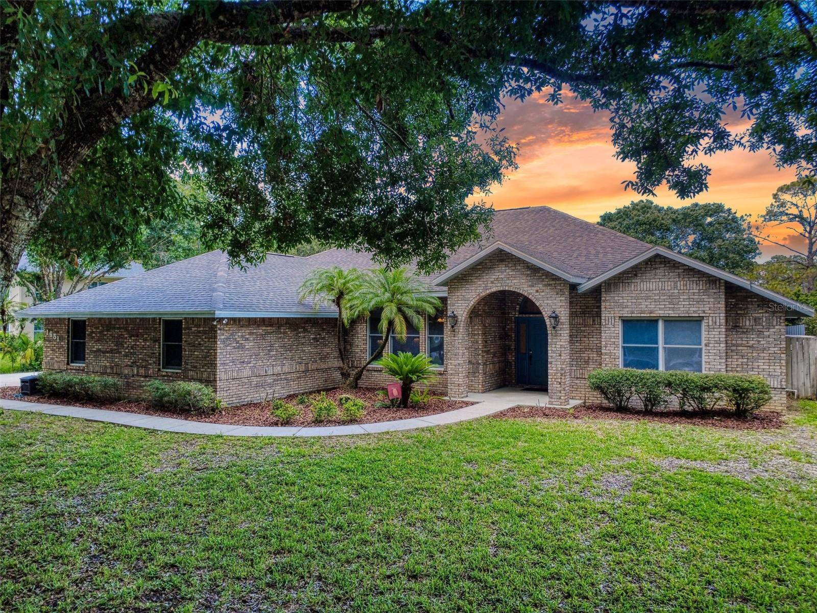 Combining the best of quiet country living with the convenience of nearby dining and shopping, this gorgeous brick executive home on over an acre of beautiful landscape is your once-in-a-lifetime opportunity to own a piece of paradise in the highly desired Seabury Point neighborhood. There are only 13 homes on this exclusive cul-de-sac, making it a rare occurrence indeed that one is offered for sale. With over 3000 sq ft under air, this stunning 4-bed, 3.5 bath pool home is perfect for large, growing, or multigenerational families.
High ceilings and an open, flowing floorplan with lots of windows showcasing the natural stone patio and pool make this the perfect home for entertaining and for making lasting family memories. Picture entertaining family and friends in the newly remodeled kitchen with brand new quartz countertops and all stainless steel appliances including a GE Trivection (conventional + convection + microwave) oven, and brand new gas cooktop. Off the kitchen lie a huge walk-in pantry and a laundry room with tons of cabinets for storage.
The kitchen opens into the family room featuring a brick wood burning fireplace and more views of the pool, beyond which you enter the expansive Primary Suite featuring a separate sitting room/office also looking out to the pool. The remodeled primary bath features a fully tiled shower with heavy glass doors, a jetted garden tub, and dual vanities. Also off the family room are two high-ceiling bedrooms with lots of closet space, with a full bathroom between.
A spacious guest suite with a cozy window seat overlooking the front yard includes a retro bathroom with glass door fully tiled shower, a pedestal sink, and an antique claw-foot bathtub. It is situated at the other side of the home from the other bedrooms for maximum privacy, and opens directly out to the pool deck.
Car enthusiasts will love the massive oversized 3 car garage offering plenty of room for 3 full size cars, projects, and storage. There is even a half-bath in there!